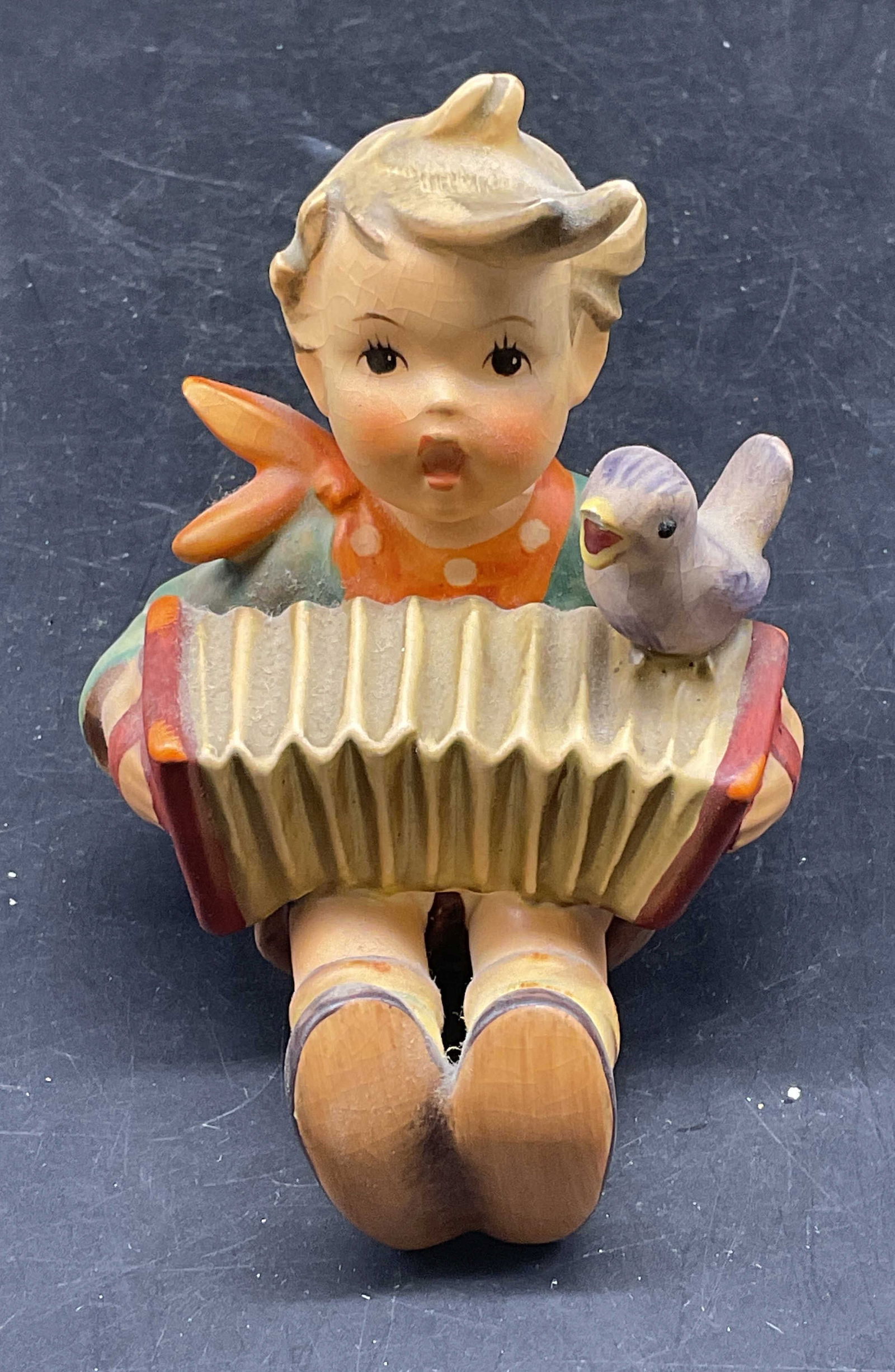 1938 GOEBEL Lets Sing Porcelain Figurine: Circa 1938 GOEBEL Hummel #111 porcelain figurine. Lets sing. Boy with accordion and bird. Measures approx. 2.75 x 3.5 inches. Some scratching and crazing. GOEBEL figurine, lets sing, collectibles, hom