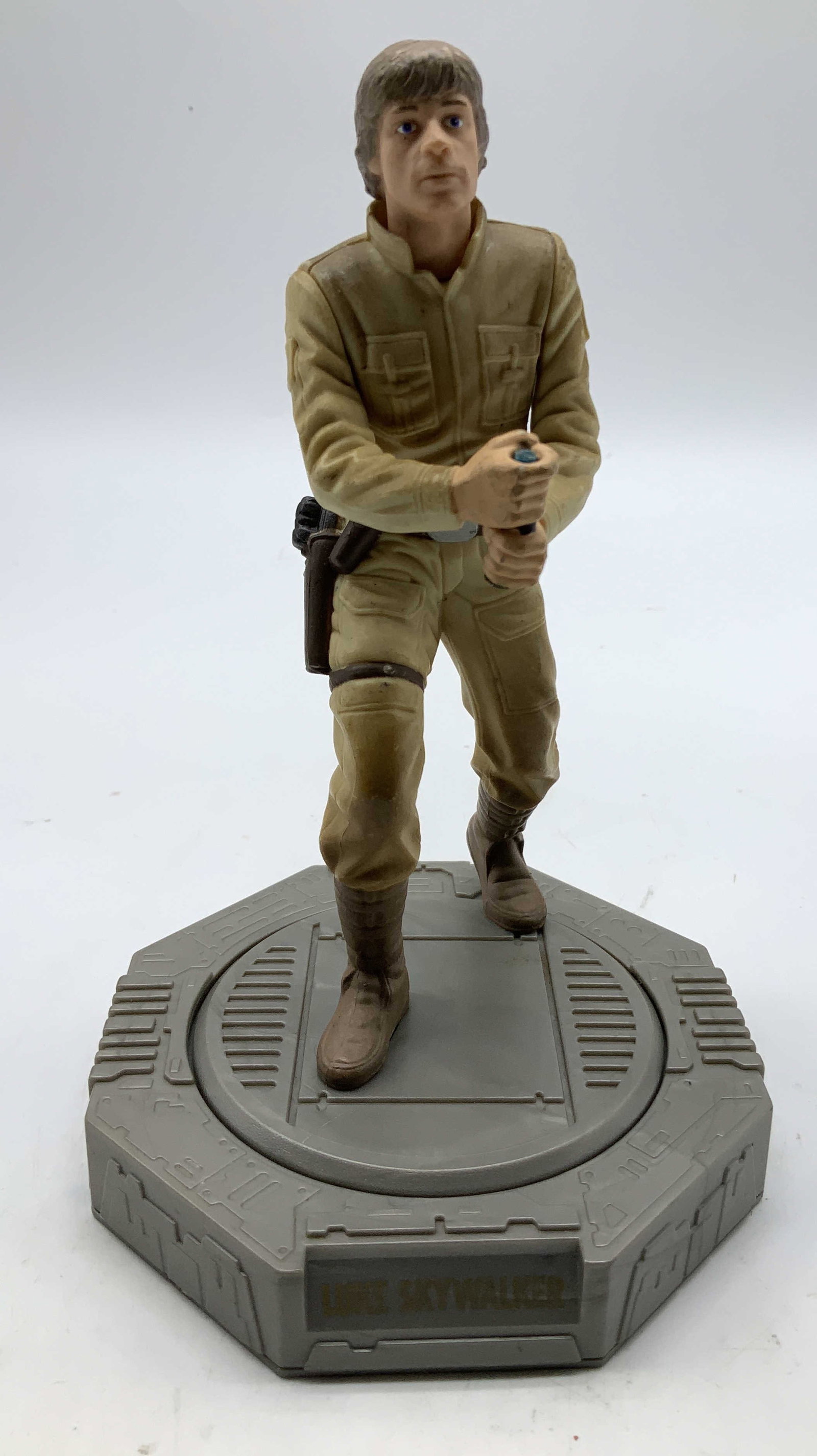 1998 Hasbro Lucas Film Luke Skywalker Action Fig: 1998 Hasbro Star Wars Luke Skywalker action figure. Beige & grey toned. Figure rotates. Base reads, Luke Skywalker. Signed & marked on underside. Reads, 1998 LUCAS FILM LTD HASBRO. Surface wear consis