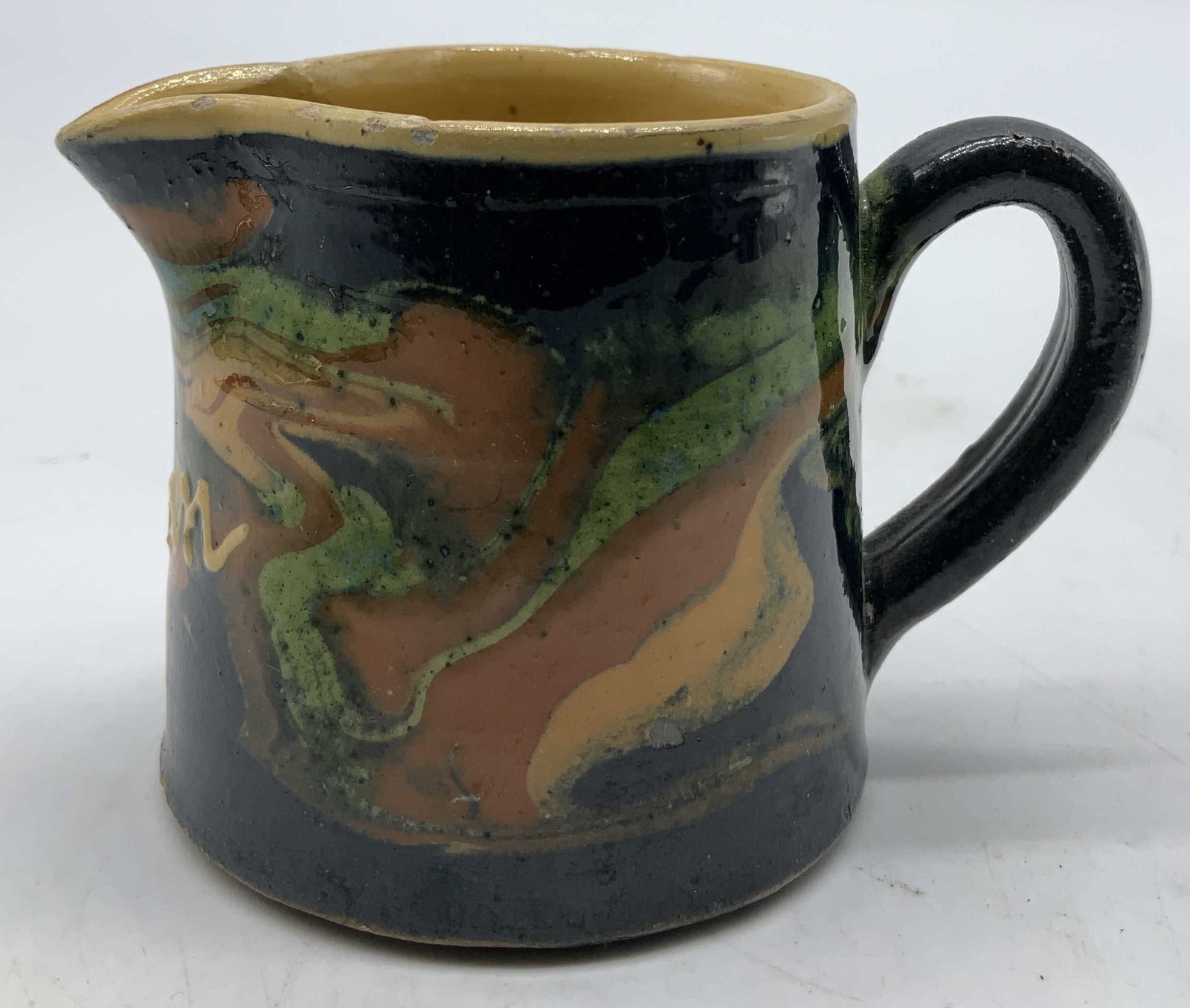 Vtg Fhertz Hand Painted Pottery Creamer: Vintage pottery creamer features a green, blue & orange glazed finish. Pinched spout. Creamer has lettering. Not legible. Signed & marked on underside. Lettering is faint. Partial readings, Fhertz. Su