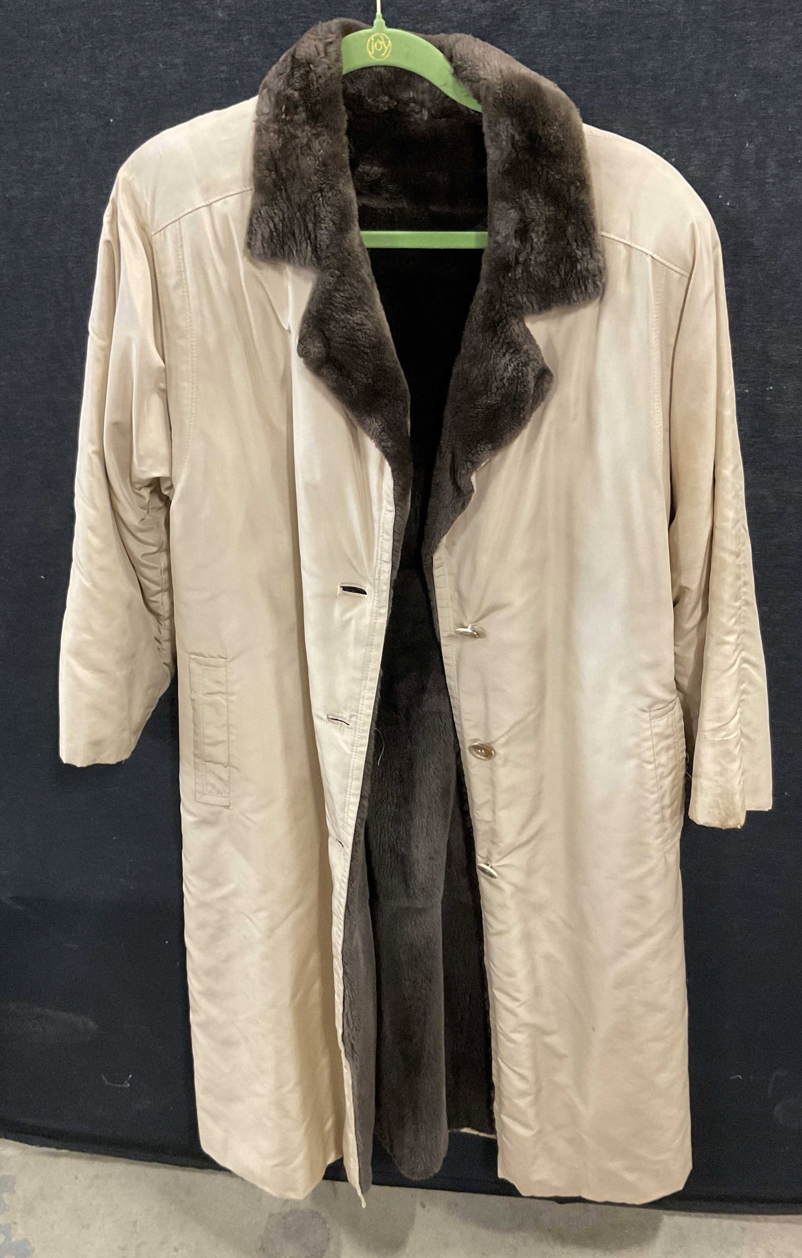 Vintage Sheared Fur Cream Colored Coat: Vintage sheared fur cream colored coat. No visible markings or tags. Brown sheared fur interior. Cream colored exterior. Front pockets. Collared. Accented buttons. Padded shoulders. Measures approx 21