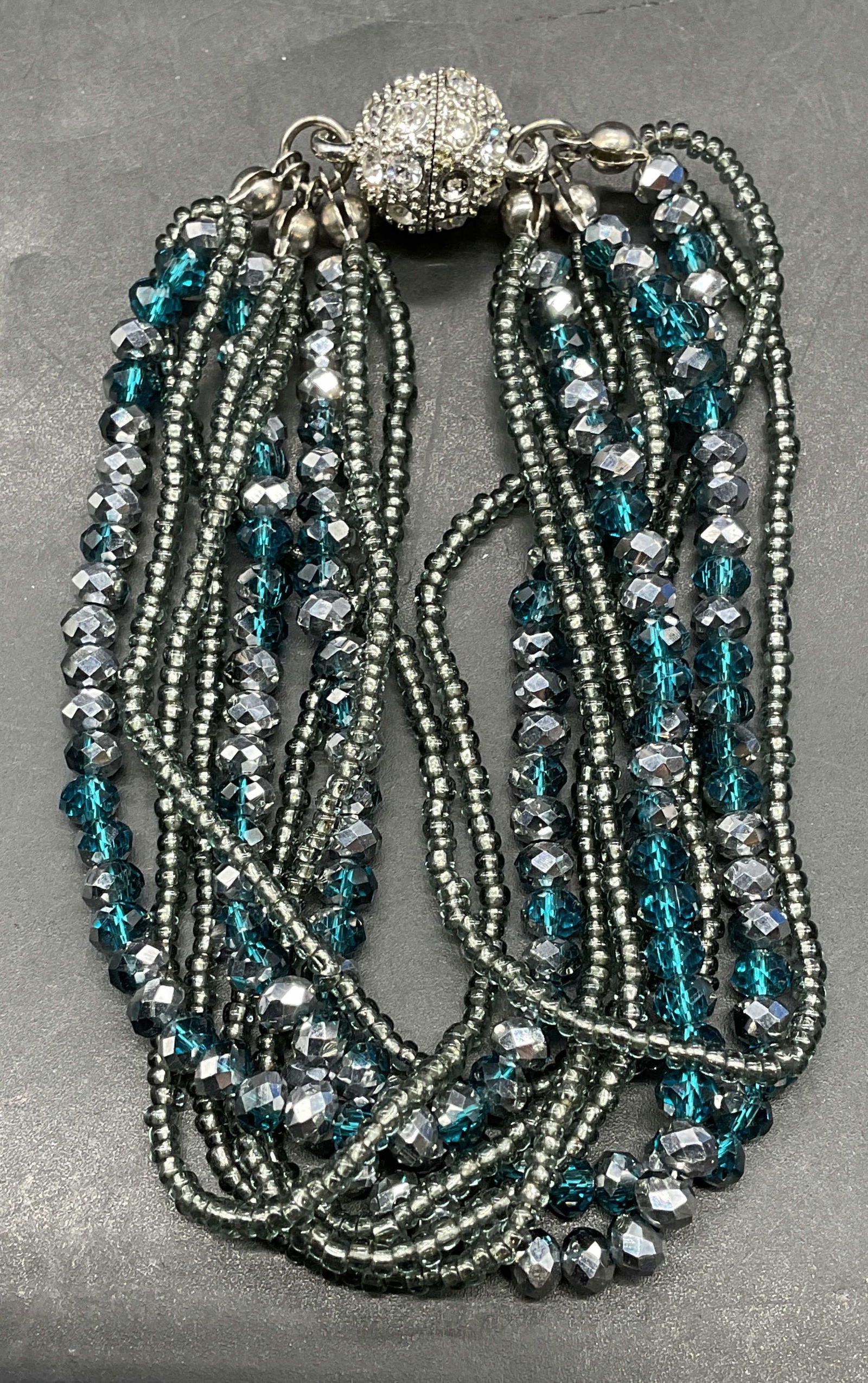 Silver Tone Blue Crystal Beaded Bracelet: Silver tone and blue crystal beaded multi strand bracelet. Measures approx 7.25 inches long. Some scratching. Jewelry, estate jewelry, costume jewelry, cocktail jewelry, fashion jewelry,