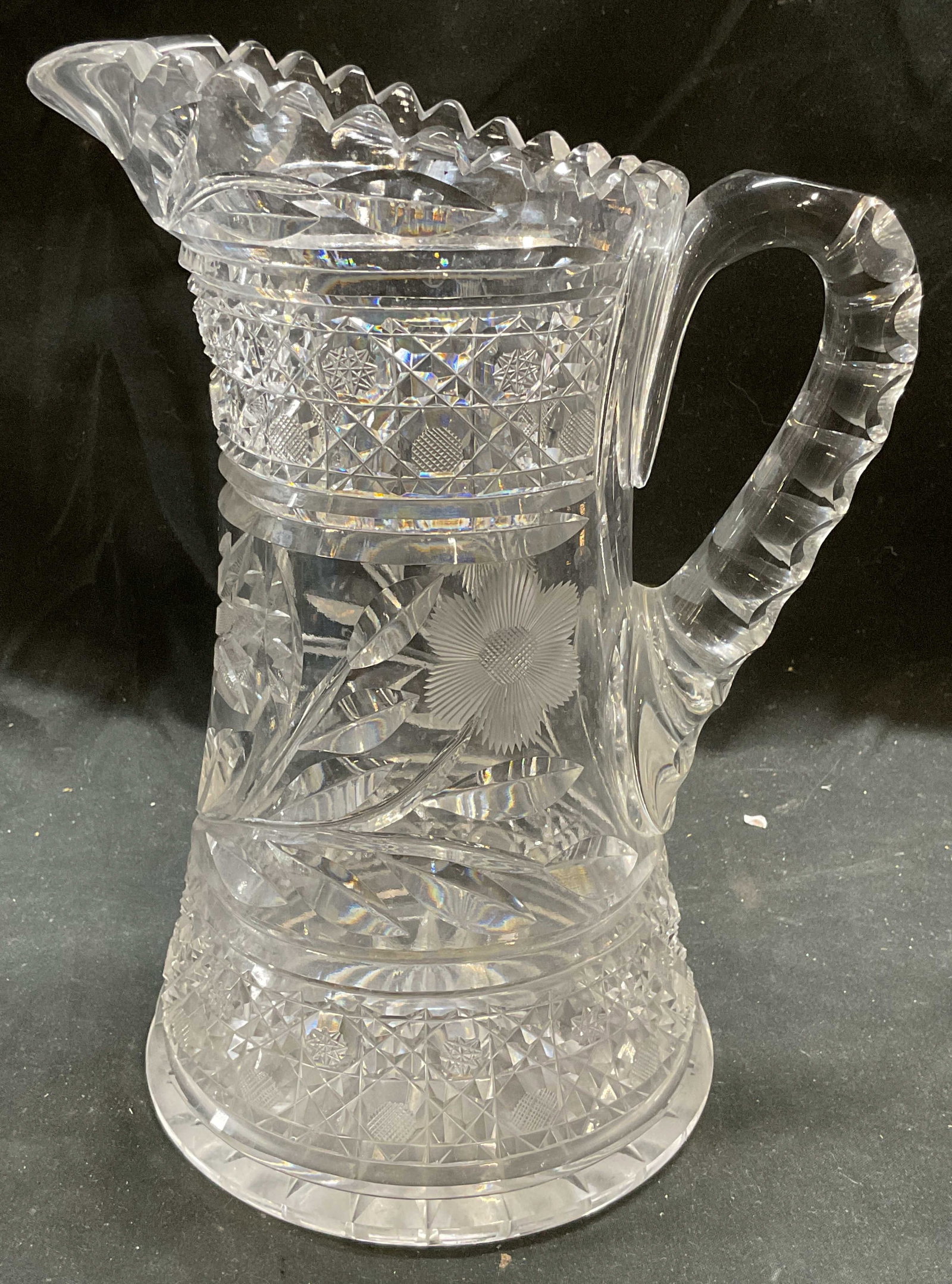 Vintage Brilliant Cut Crystal Pitcher: Vintage, possibly antique, American Brilliant Period style cut crystal pitcher. Ornate botanical floral and diamond patterns. Sawtooth rim. Thick walled crystal, piece has weight. Measures approx 7 x
