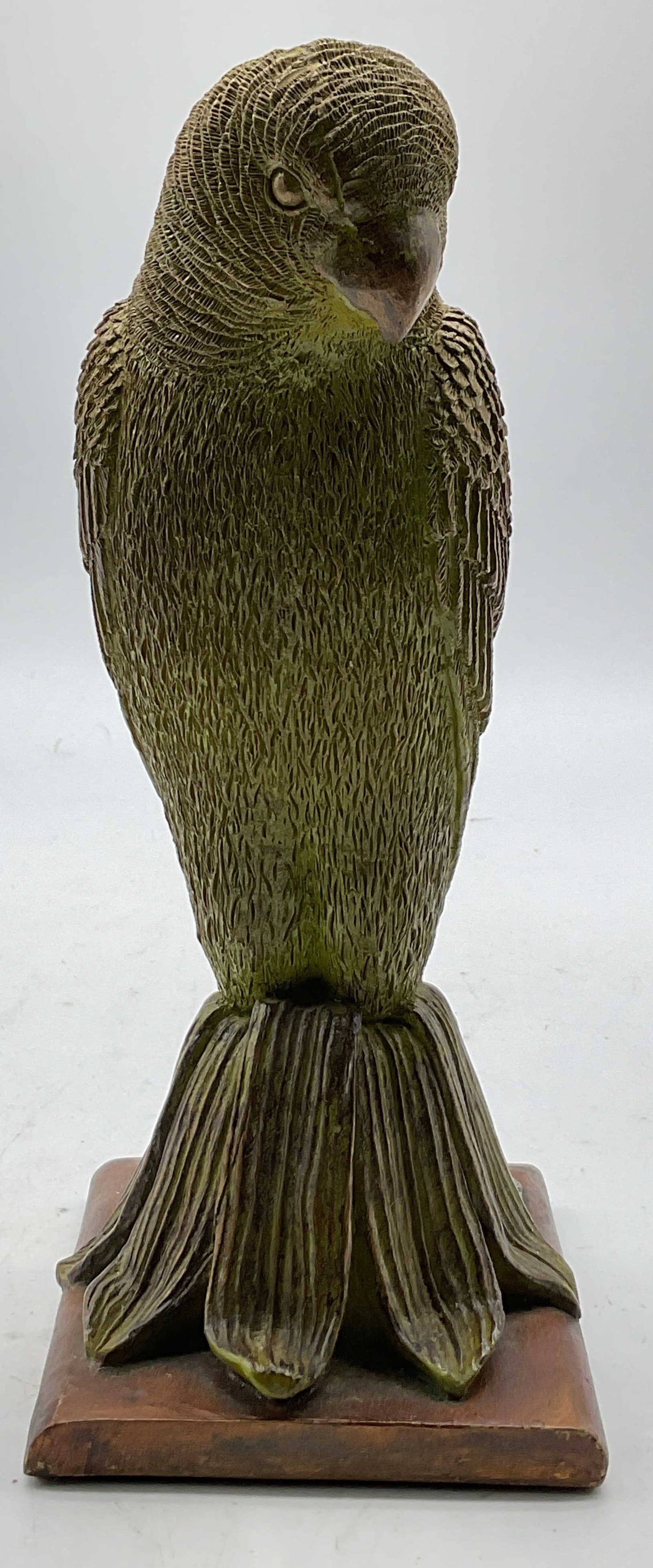 Vintage Gold Toned Parrot Figure: Vintage gold toned resin parrot figure. Square brown toned base. Parrot figure. Gold toned and green. Detailed features and textures. Scalloped edge. Measures approx 3.5 x 4 x 8 inches. Surface