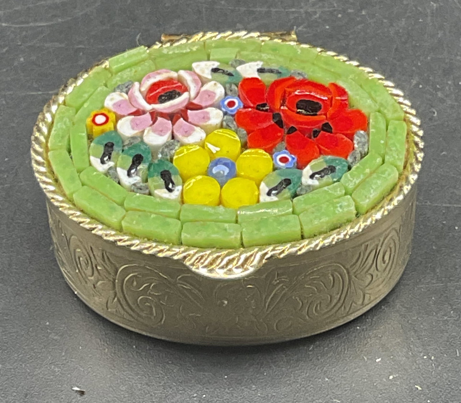 Vintage Micro Mosaic Floral Trinket Pill Box: Vintage gold tone trinket box with micro mosaic glass lid. Floral design. Measures approx. 1.25 x 1 x 5/8 inches. Some scratching. Micro mosaic trinket box, floral trinket box, collectibles, home deco