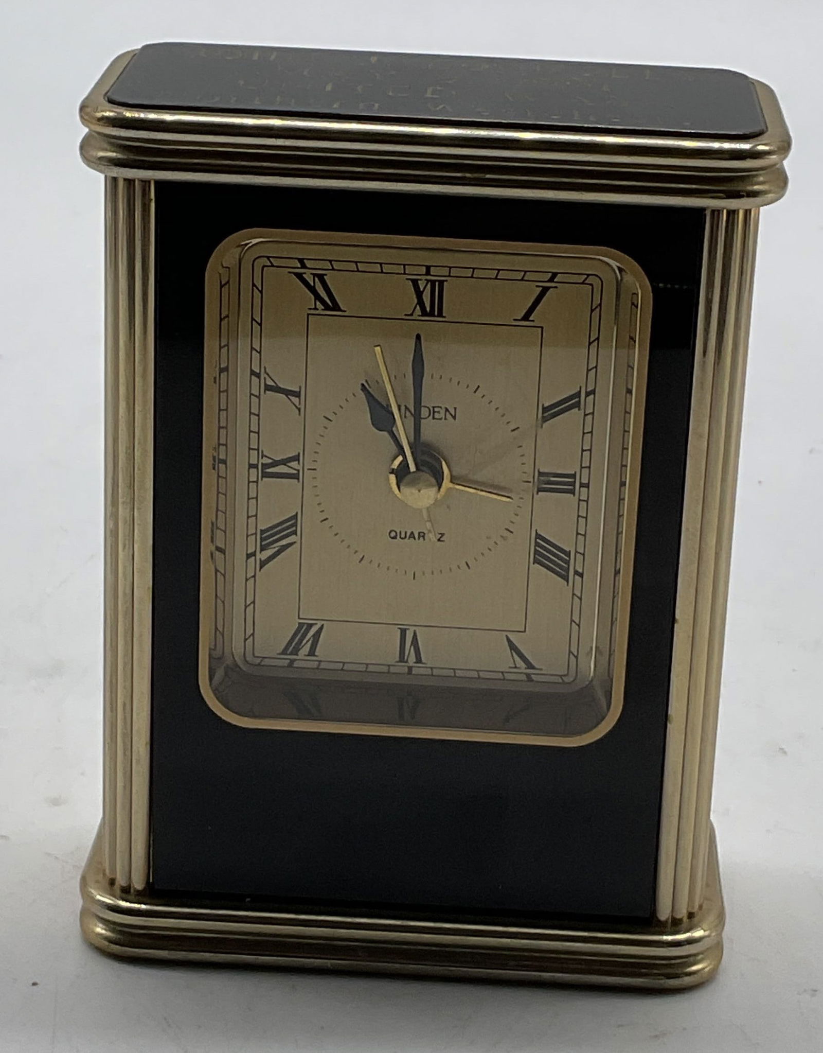Linden Quartz Gold Toned Desk Clock: Linden Quartz gold toned desk clock. Face reads Linden Quartz. Inscription on top, reads as photographed here. Rectangular shape with ribbed surface. Measures approx 1.5 x 3 x 4 inches. Not tested for