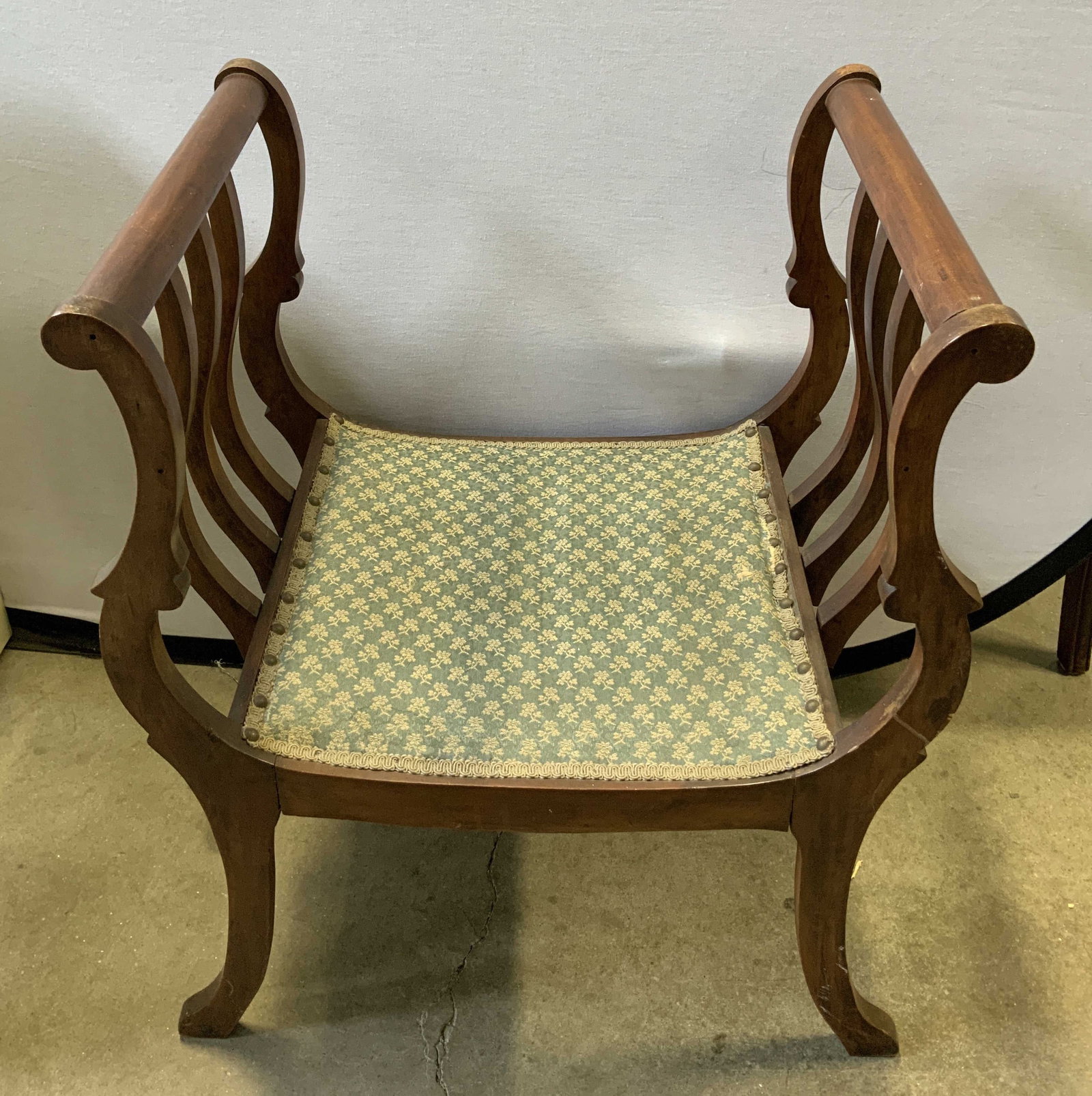 Vtg Victorian Style Bustle Chair 28.8in: Vintage Victorian Style bustle chair features a low seat & two curved slat sides. Dark toned. Seat is upholstered in a blue toned & features floral motifs. No visible signature or markings. Surface we