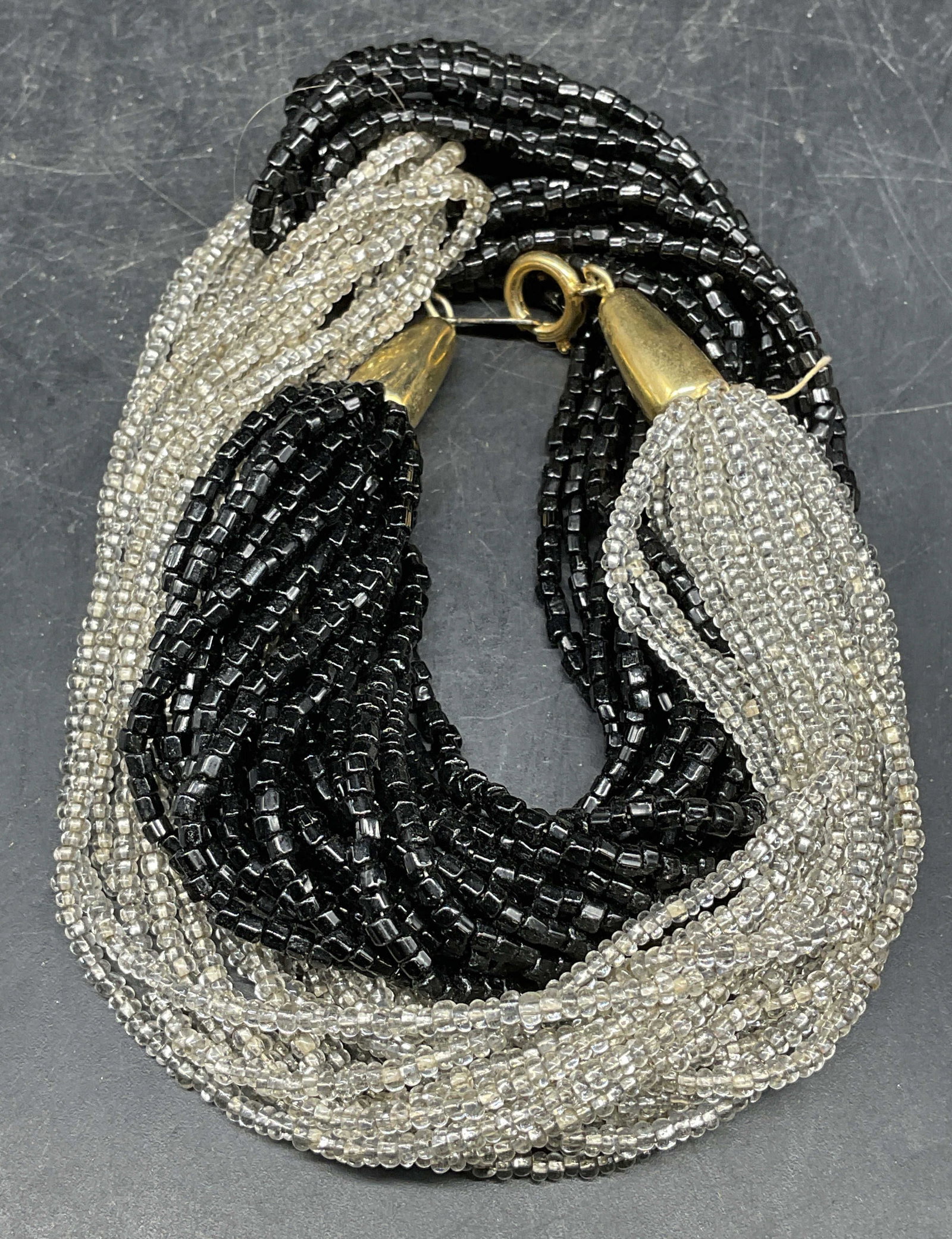 Vintage Black & Clear Seed Beaded Necklace: Vintage multi strand interlocking black and clear seed beaded necklace. Drop length measures approx. 7.5 inches. Some scratching. Jewelry, estate jewelry, costume jewelry, cocktail jewelry, fashion je