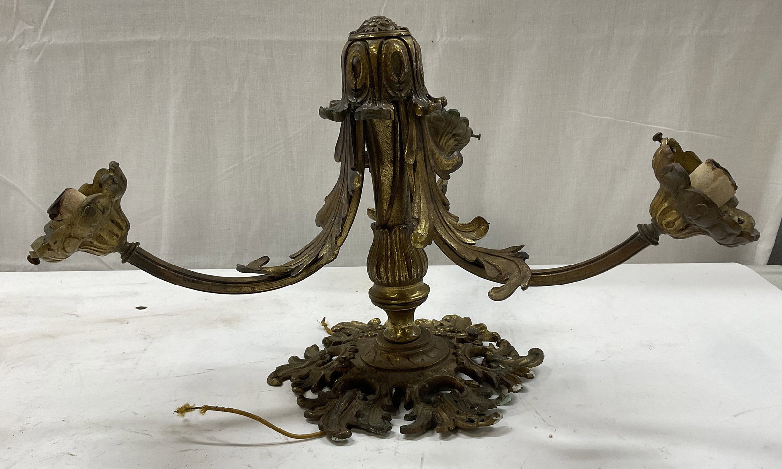 ATQ 3-Arm Brass Wall Sconce: ATQ 3-Arm Brass Wall Sconce. Intricate Acanthus Leaf Design. Gilded finish. French Style. Surface wear consistent with exposure. Some paint present. Has not been tested for functionality. Measures app