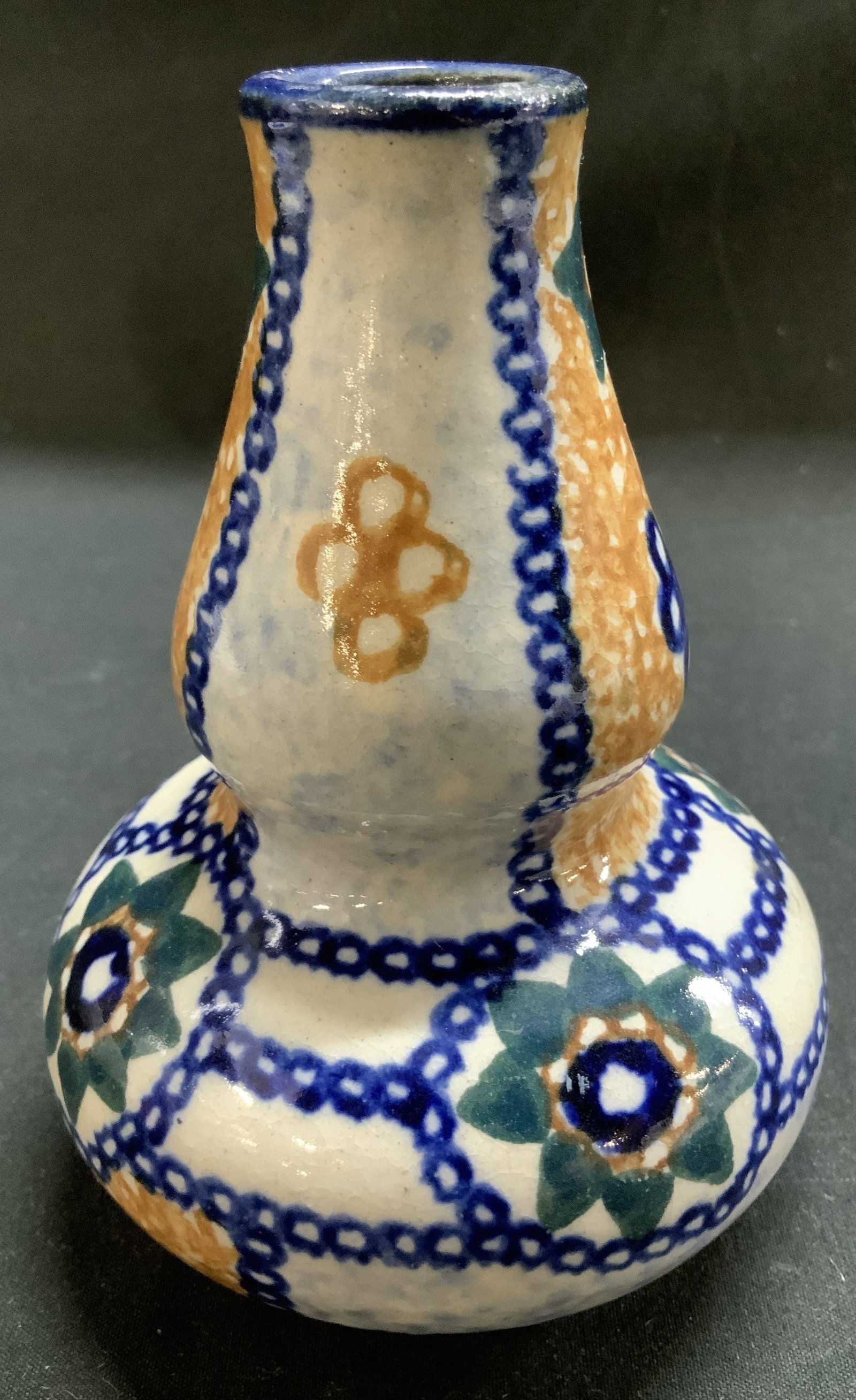 Vtg Hand Painted Pottery Vase GERMANY: Vintage pottery vase features an hourglass shape. Hand painted chain-link patterns & stylized floral motifs. Shades of orange, blue, white, green. Signed & marked on underside. Reads, GERMANY. Surface