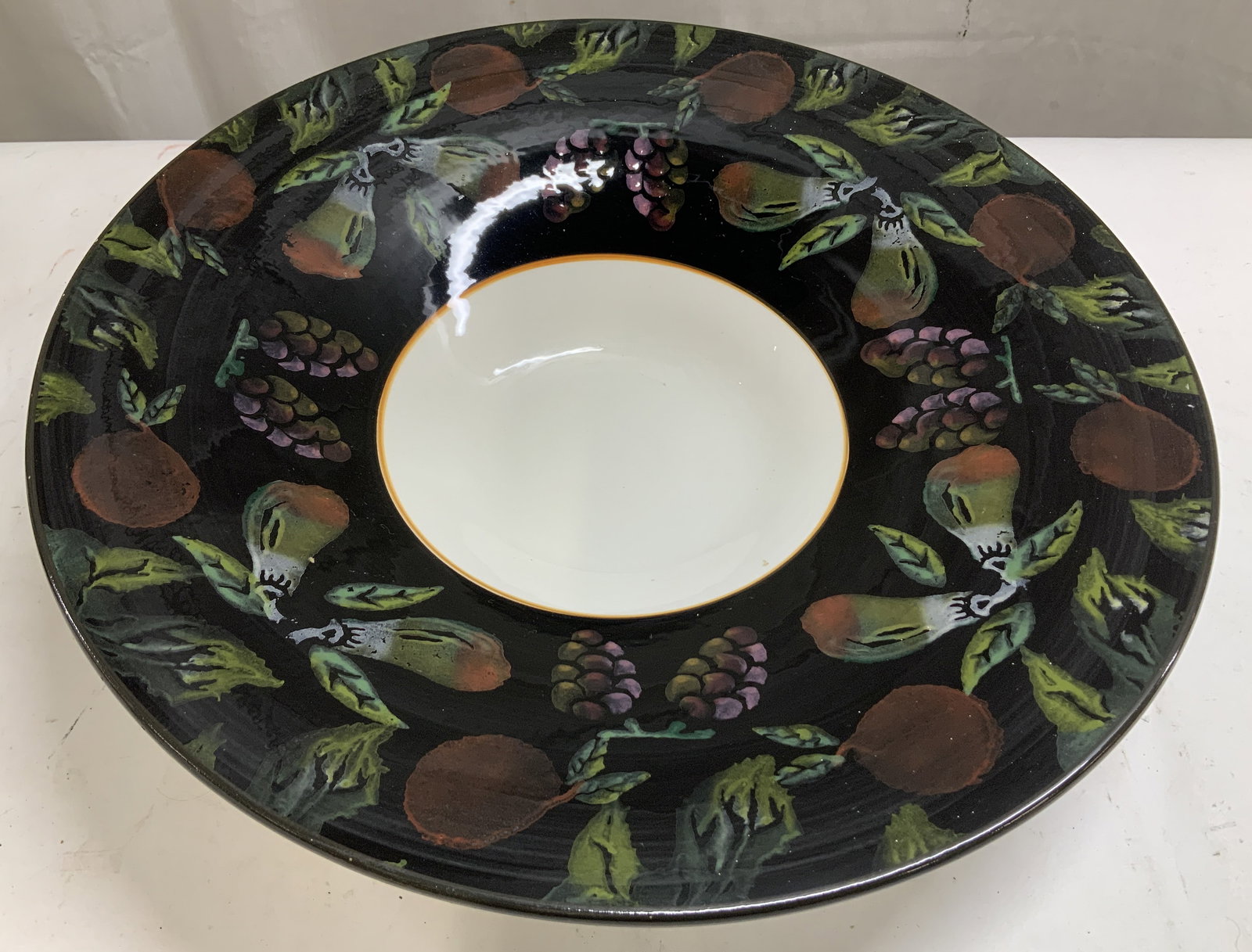 ARM Hand Painted Fruit Motif Serving Bowl Italy: ARM hand painted serving bowl features a fruit motif design on rim. White center. Ceramic material. Glossy finish. Signed & marked on underside. Reads, MADE IN ITALY. ARM. Surface wear consistent to a