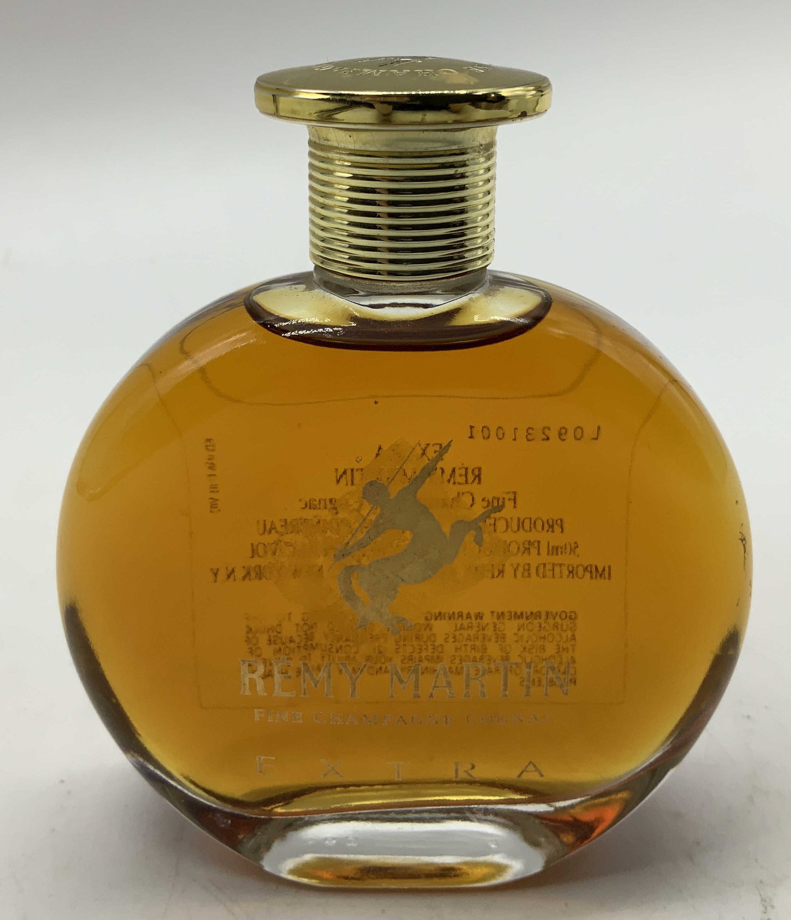 Remy Martin Extra Fine Champagne Coganc: Remy Martin Extra Fine Champagne Cognac. Produced by CLS REMY COINTREAU. Features a round shape & gilt top. Surface wear consistent to age, use & exposure. Signed & marked. Reads, PRODUCT OF FRANCE. M