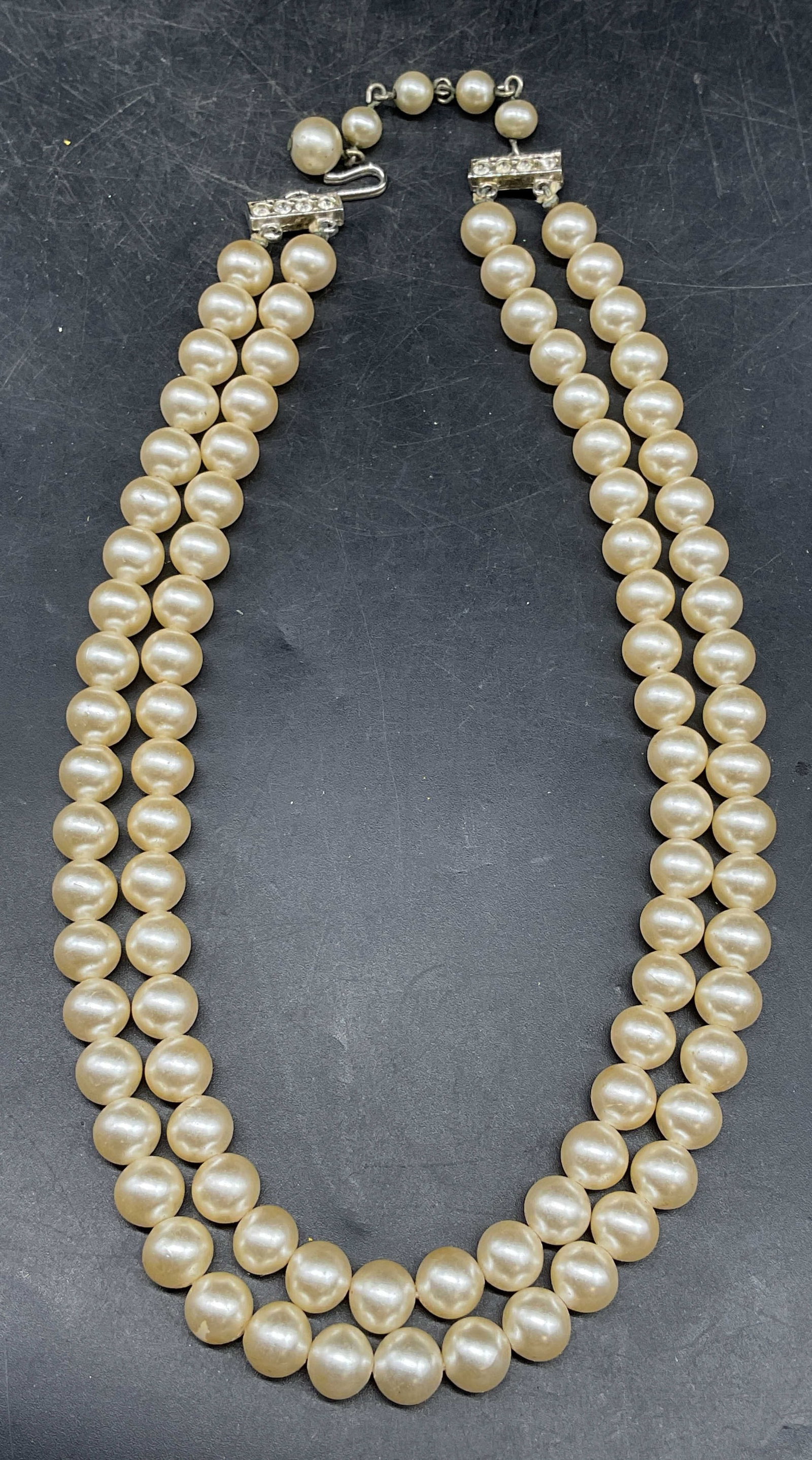 Vintage Double Strand Faux Pearl Necklace: Vintage double strand faux pearl beaded necklace with crystal clasp. Drop length measures approx. 6.5 inches. Some scratching. Jewelry, estate jewelry, costume jewelry, cocktail jewelry, fashion jewel