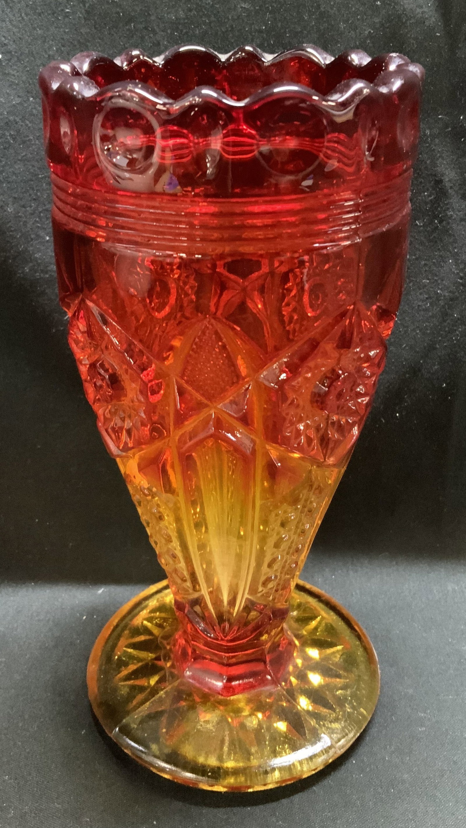 Vtg Amberina Geometric Motif Glass Vessel: Vintage Amberina glass vessel featuring geometric motifs. Scalloped top. Red top to a yellow base. No visible signature or markings. Surface wear consistent to age, use & exposure. Measurements