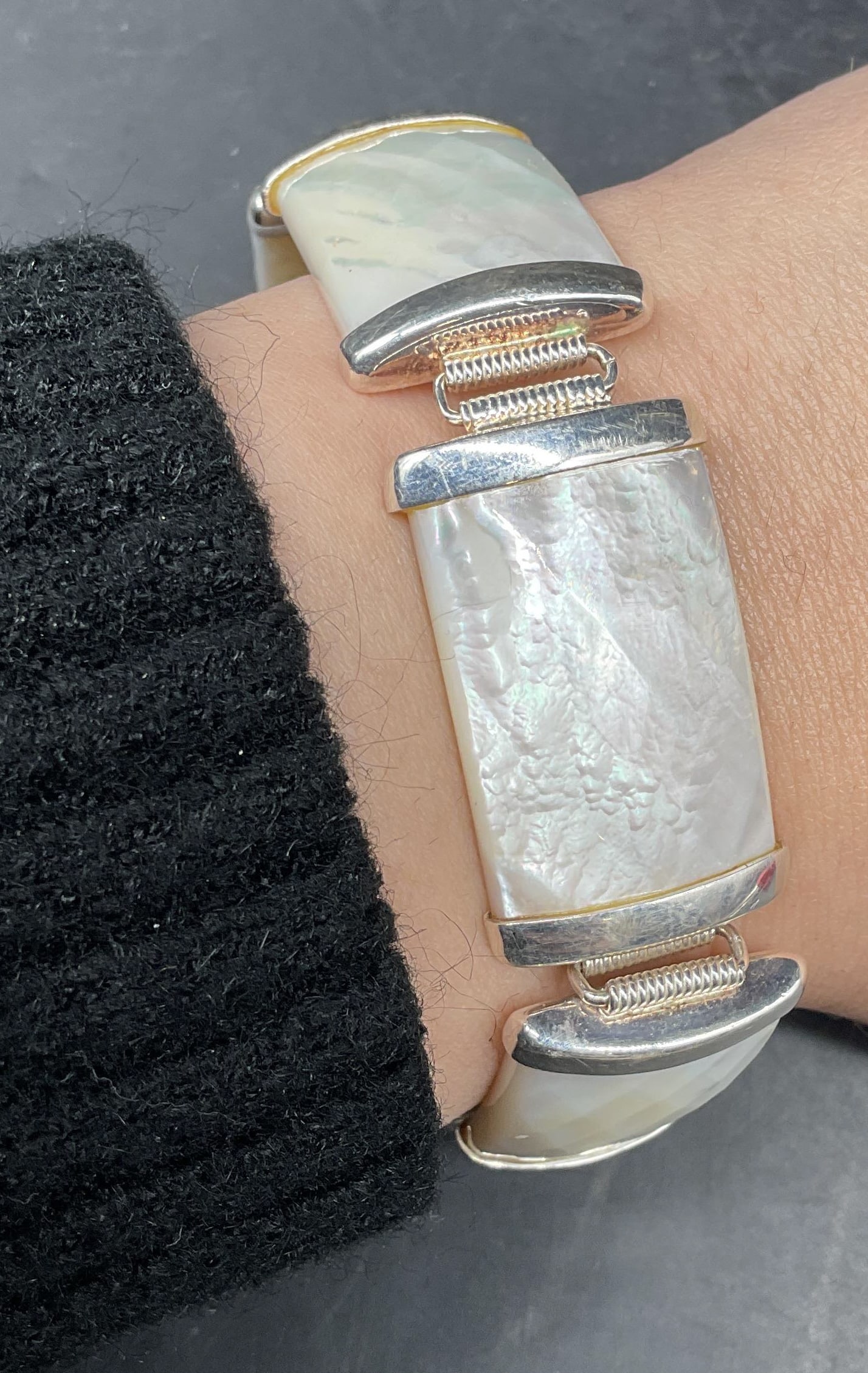Sgn Sterling Silver & Mother of Pearl Bracelet: Signed bracelet with faceted mother of pearl panels and sterling silver accents. Marked sterling. Signed with hallmark. Measures approx. 7,5 inches long. Total weight 45.3 grams. Some scratching. Jewe