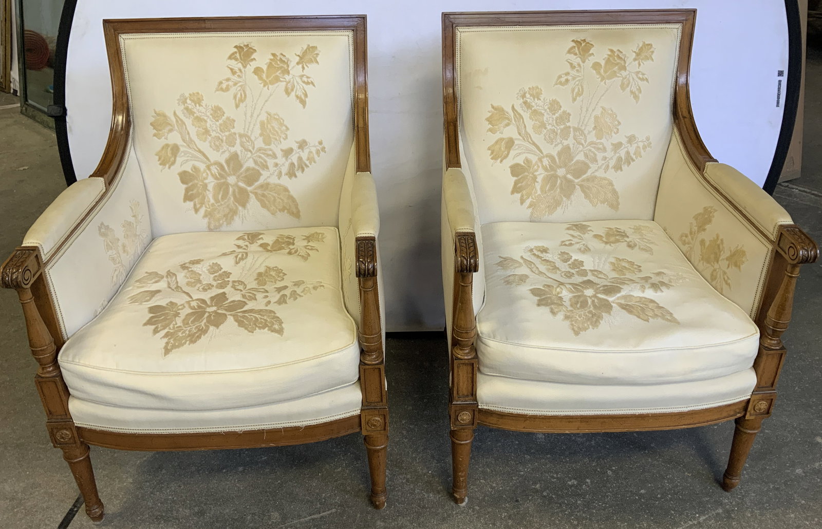 Pair Vtg French Louis XVI Style Armchair: Lot includes, a pair of vintage French Louis XVI style armchair. Craved detailing on wood. Cream colored fabric with floral detailing. No visible signature or markings. Surface wear consistent to age,