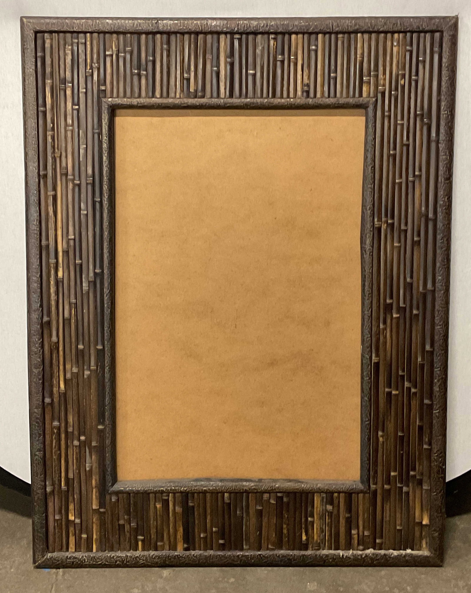 Dark Brown Laminated Bamboo Frame 29in: Dark brown finish laminated bamboo picture or art frame. Frame has significant weight. Measures approx. 43 x 33 inches, window approx 29.5 x 19.5 inches. Wear including scratching and rubbing to corne