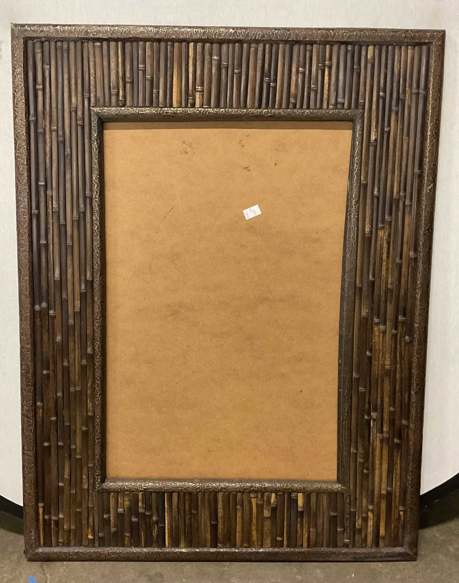 Dark Brown Laminated Bamboo Frame 29in: Dark brown finish laminated bamboo picture or art frame. Frame has significant weight. Measures approx. 43 x 33 inches, window approx 29.5 x 19.5 inches. Wear including scratching and rubbing to corne