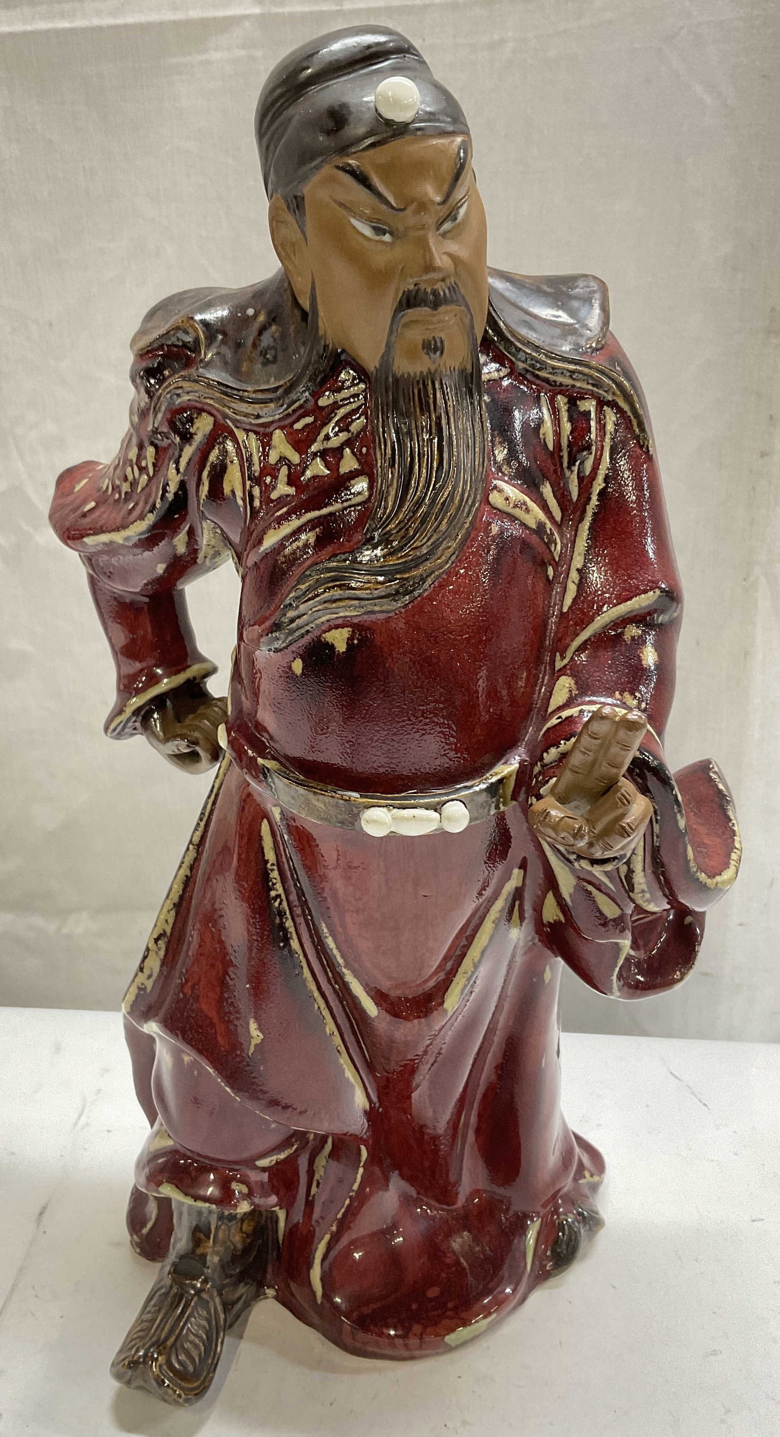 VTG SGND Chinese Shiwan Pottery Guan Yu Statue: Vintage Chinese Shiwan Pottery Guan Yu Statue. Shiwan Stoneware with Oxblood Glaze on Robes. Hollow on the Inside. Interior Signed with Asian Characters. Condition Consistent with Exposure. Measures a