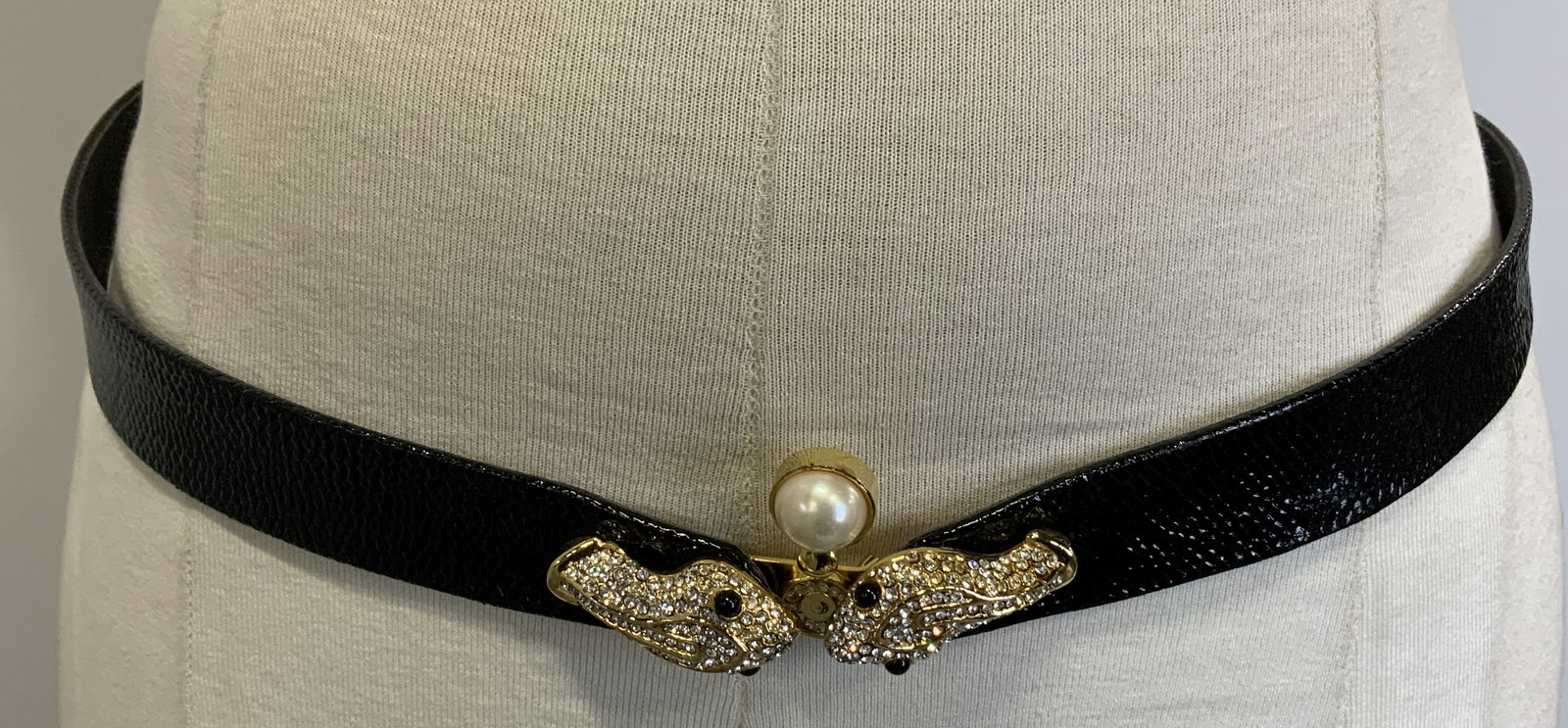 Vtg Ashneil Snake Head Leather Belt HONG KONG: Features rhinestone-studded snake head clasps. Vintage Ashneil black leather belt featuring 2 reptile heads & faux pearl. Rhinestone accents. Signed & marked. Reads, MADE IN HONG KONG. Surface wear co