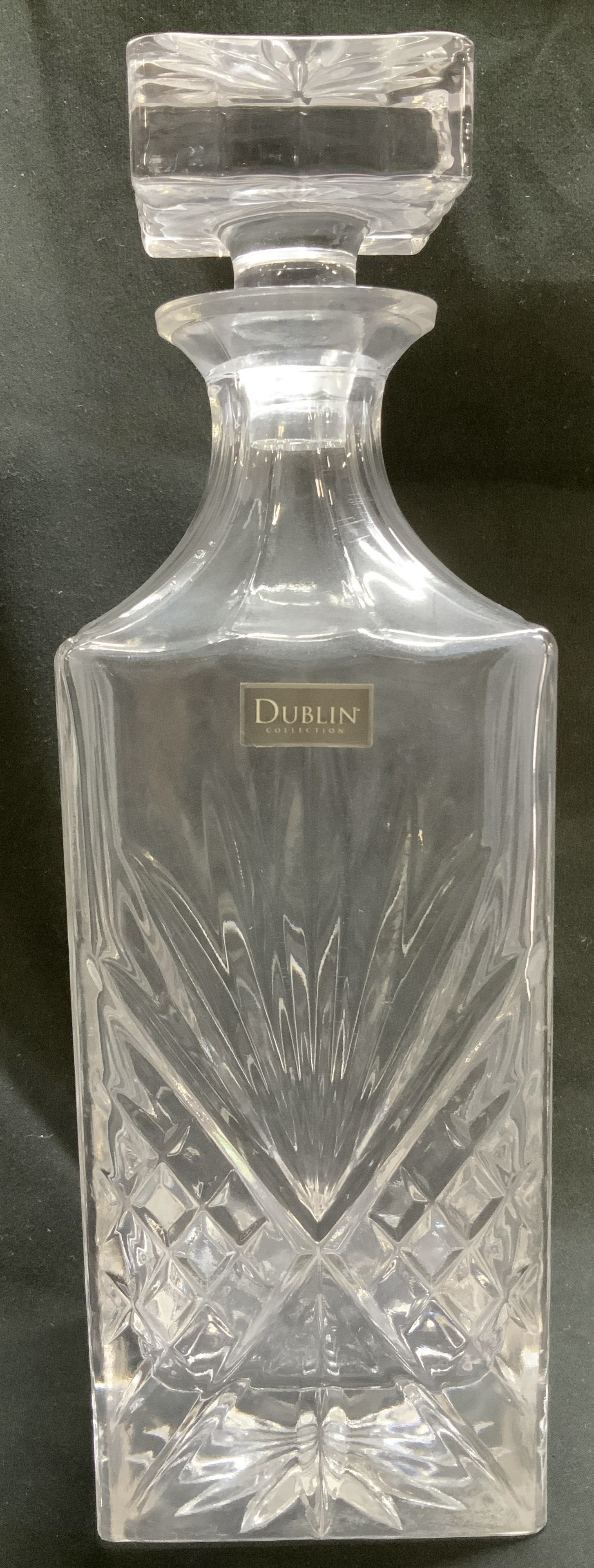 Dublin Collection Crystal Decanter W Stopper: Dublin Collection crystal decanter features an intricate diamond cut pattern on body. Square shape. Signed & marked. Reads DUBLIN COLLECTION. Surface wear consistent to age, use & exposure. Measuremen