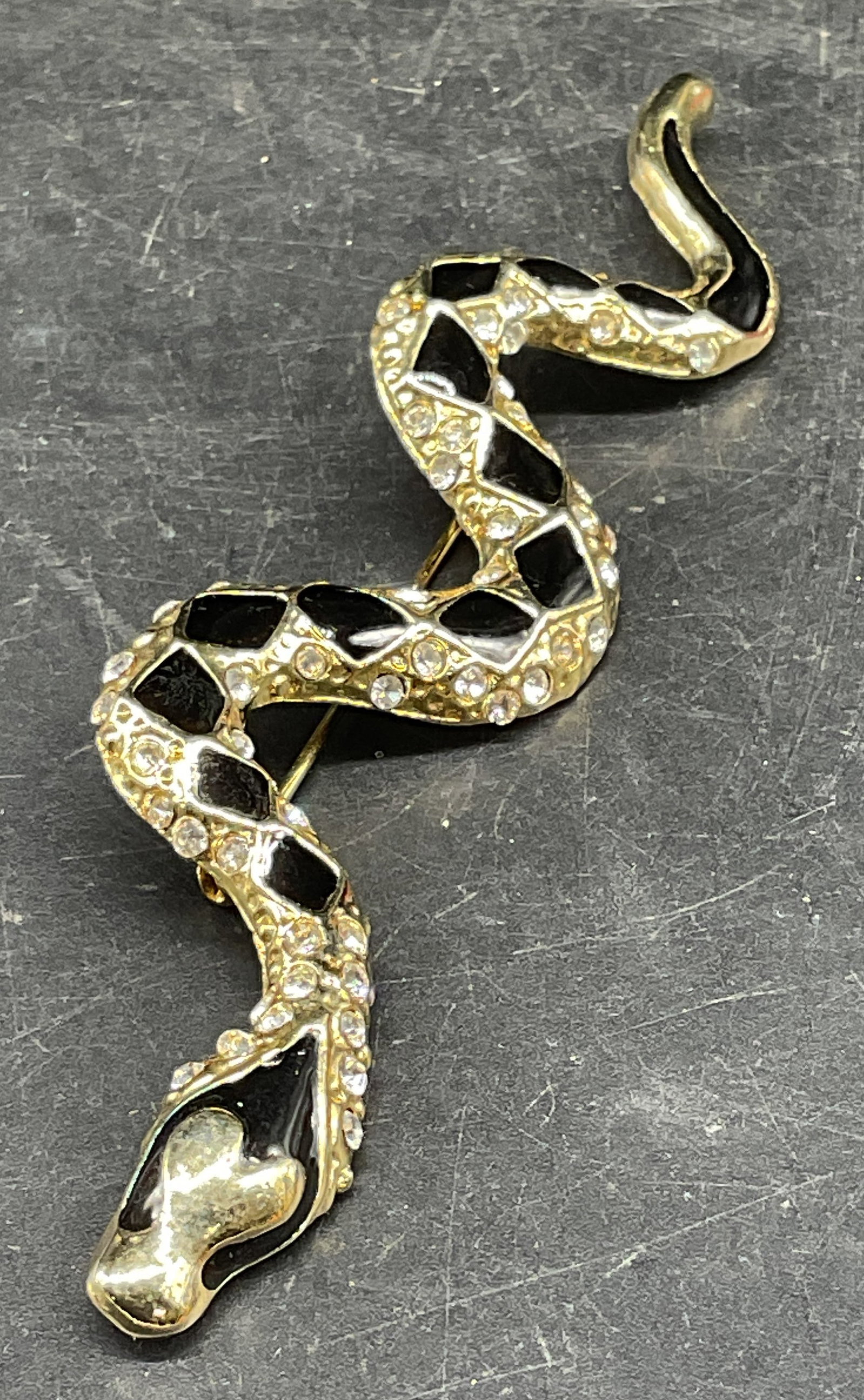 Gold Tone Crystal Snake Brooch 4 In Long: Vintage gold tone black enamel and crystal decorated snake motif brooch. Measures approx. 4 inches long. Some scratching. Jewelry, estate jewelry, costume jewelry, cocktail jewelry, fashion jewelry, a