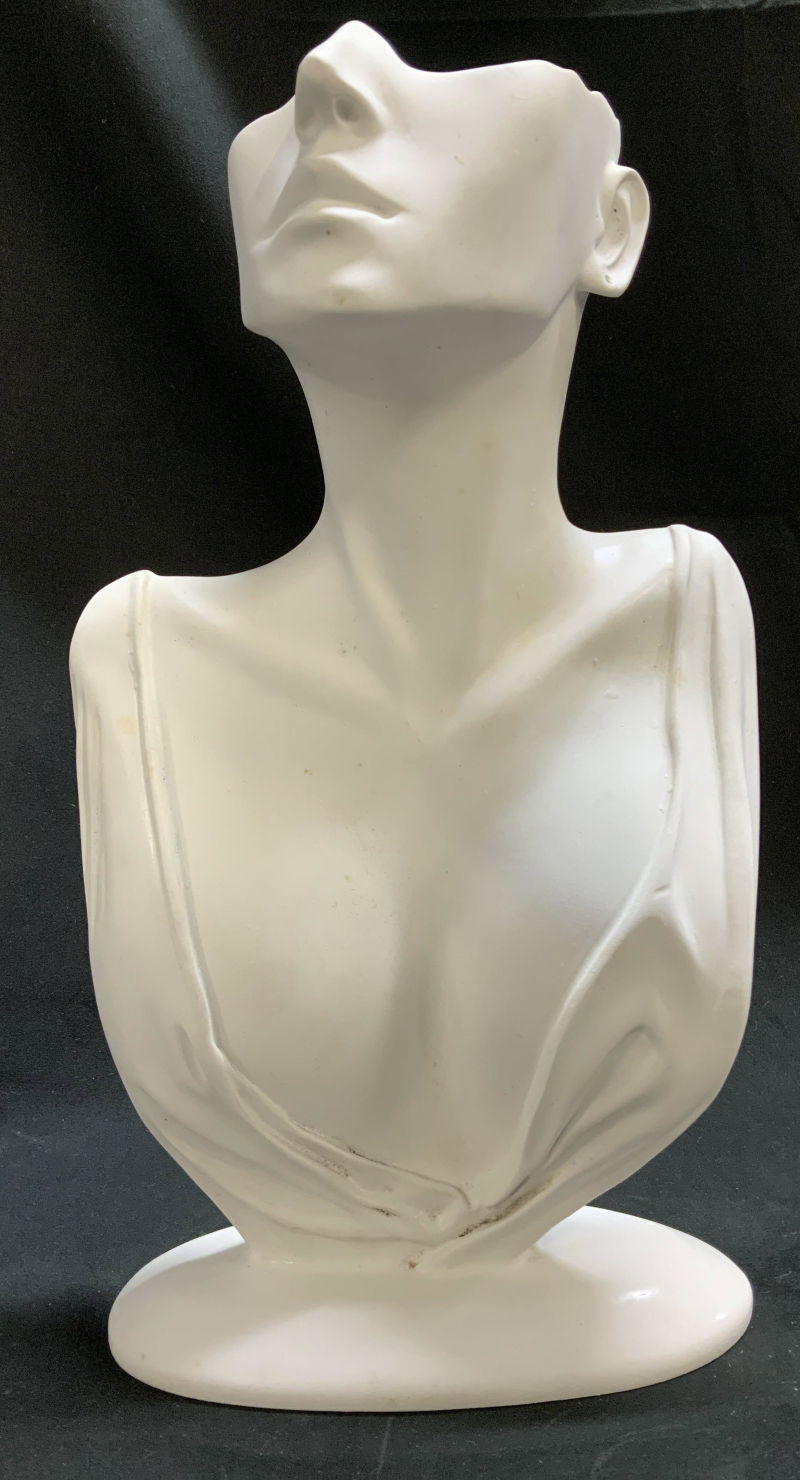 Jewelry Display Female Bust 12.3in: Jewelry display shaped as a female bust. White toned. Holds necklaces & earrings. Surface wear consistent to age, use & exposure. Measurements: length 6.7in x width 3in x height 12.3in. Necklace & ear
