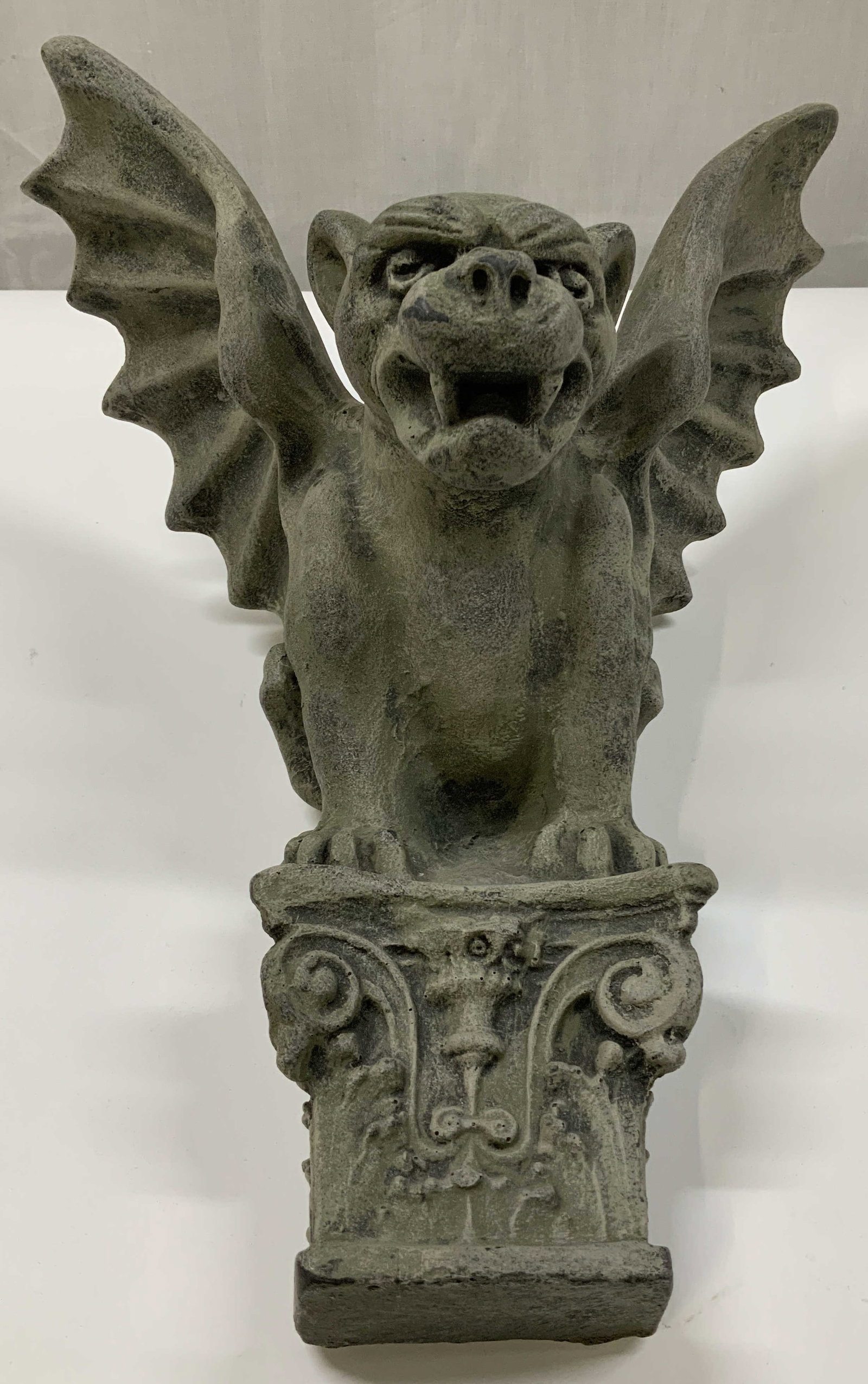 Winged Dog Gargoyle Wall Sculpture: Wall sculpture depicting a winged, dog like creature perched on a deco column like. Grey toned. Composite material. Signed & marked on underside. Visible numbers. Measurements: height to wings 13.2in 