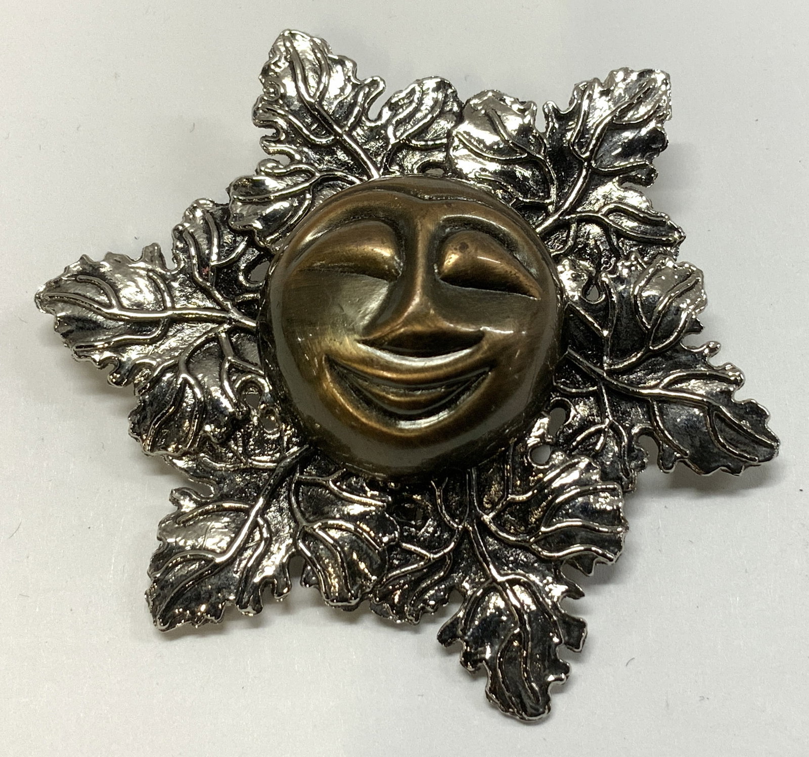 Vtg Sylvia Dahl Happy Man in the Moon Clip: Vintage Sylvia Dahl Happy Man in the Moon clip featuring a smiling face & leaf accents. Silver & copper toned. Surface wear consistent to age, use & exposure. Signed & marked on underside. Reads, SYLV