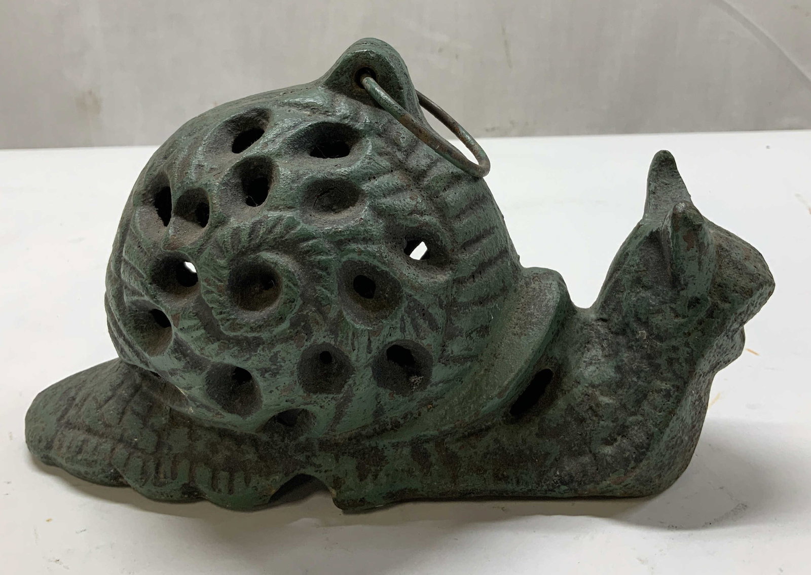 Vtg Cast Iron Snail Candle Holder: Vintage cast iron snail candle holder features a dark green finish & various holes on shell for light. Handle at top. Surface wear consistent to age, use & exposure. Measurements: length 7.5in x width