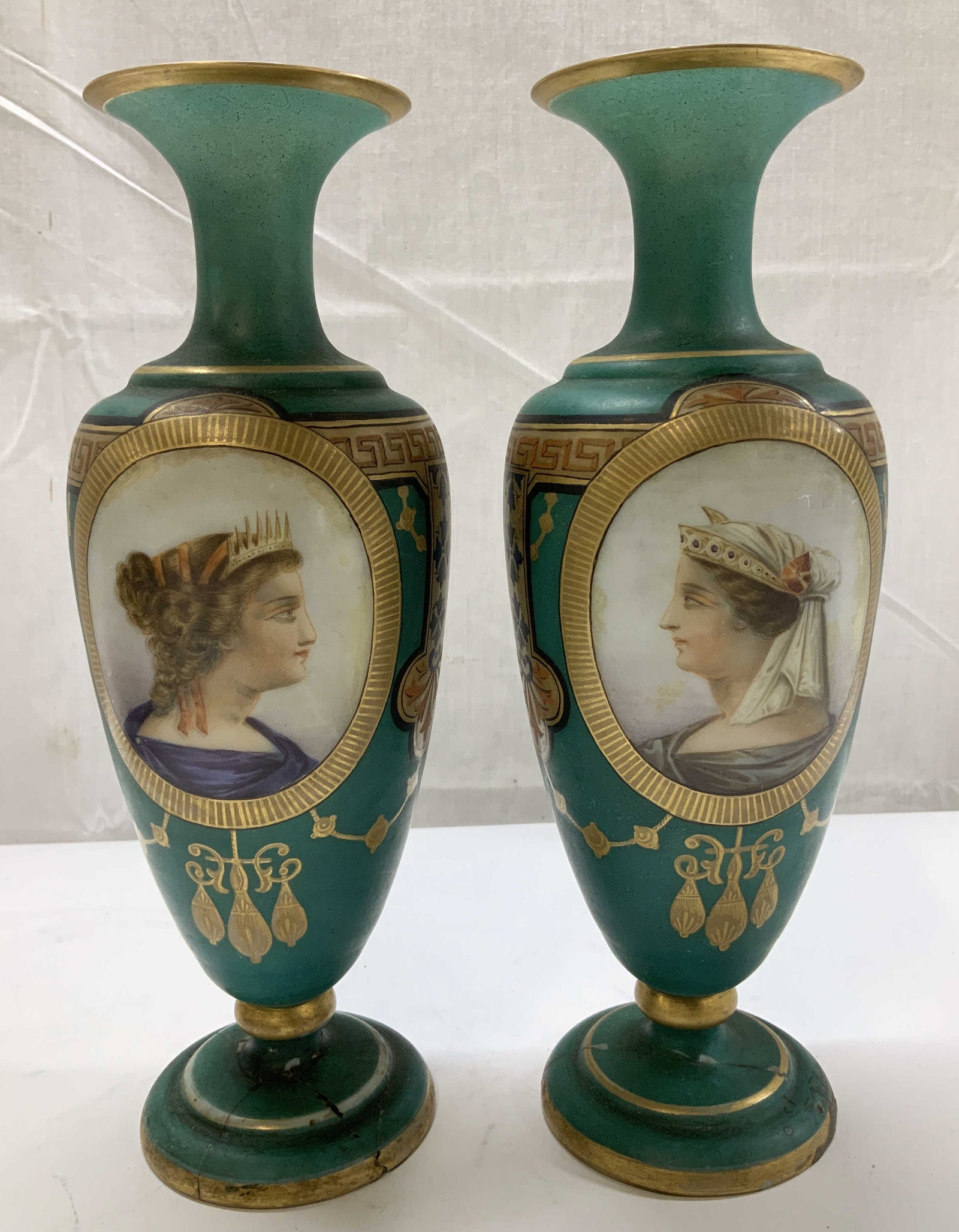 Pair Antique Hand Painted Portrait Glass Vases: Lot includes, a pair of antique glass vases featuring hand painted portraits on body. Intricate gilt accents & a Greek key pattern. Round base & small neck. Antique, possible vintage. Sold as is. Surf