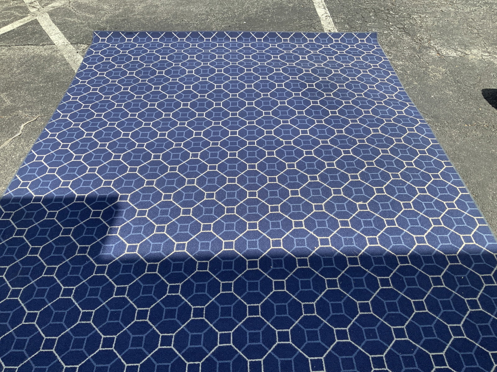 Vtg Blue & White Geometric Rug: Vintage rug is blue & white toned. Features a geometric pattern. Synthetic material. Surface wear consistent to age, use & exposure. Measurements: length 124in x width 100.5in. Vintage blue & white ge