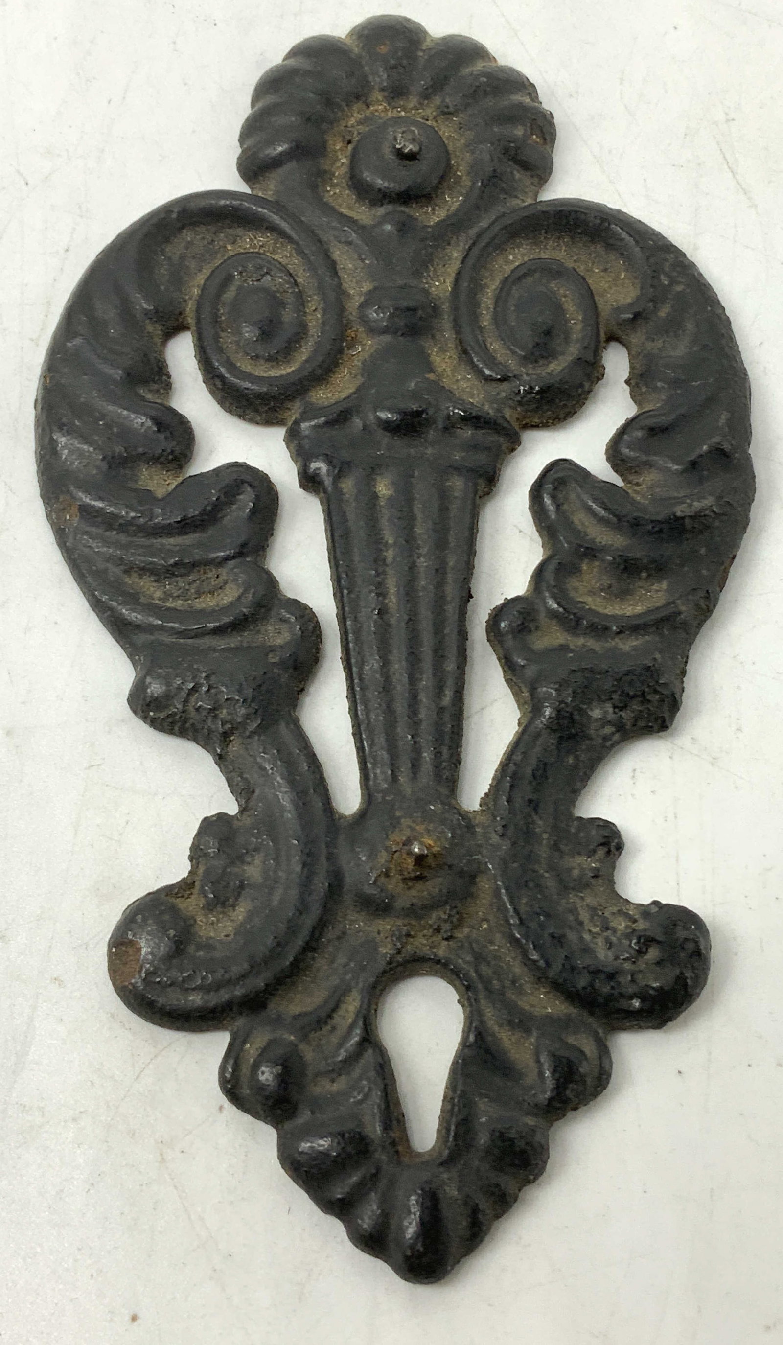 Vtg Cast Iron Ornate Escutcheon Plate: Vintage cast iron escutcheon plate with a keyhole. Scroll detailing. Black toned. No visible signature or markings. Surface wear consistent to age, use & exposure. Measurements: length 6.2in x width 3