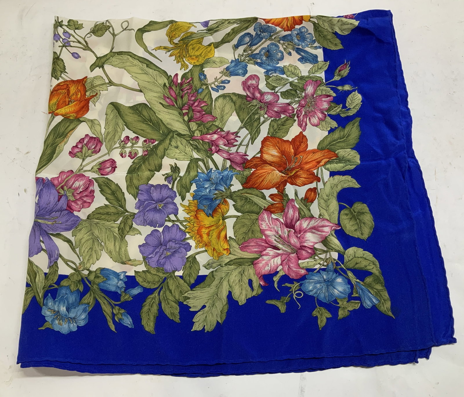 Vtg Botanical Silk Square Scarf: Vintage scarf featuring a vibrant botanical design on a white background with a blue border. Feels like possible silk. Square shape. Sold as is. No visible signature or markings. Surface wear consiste