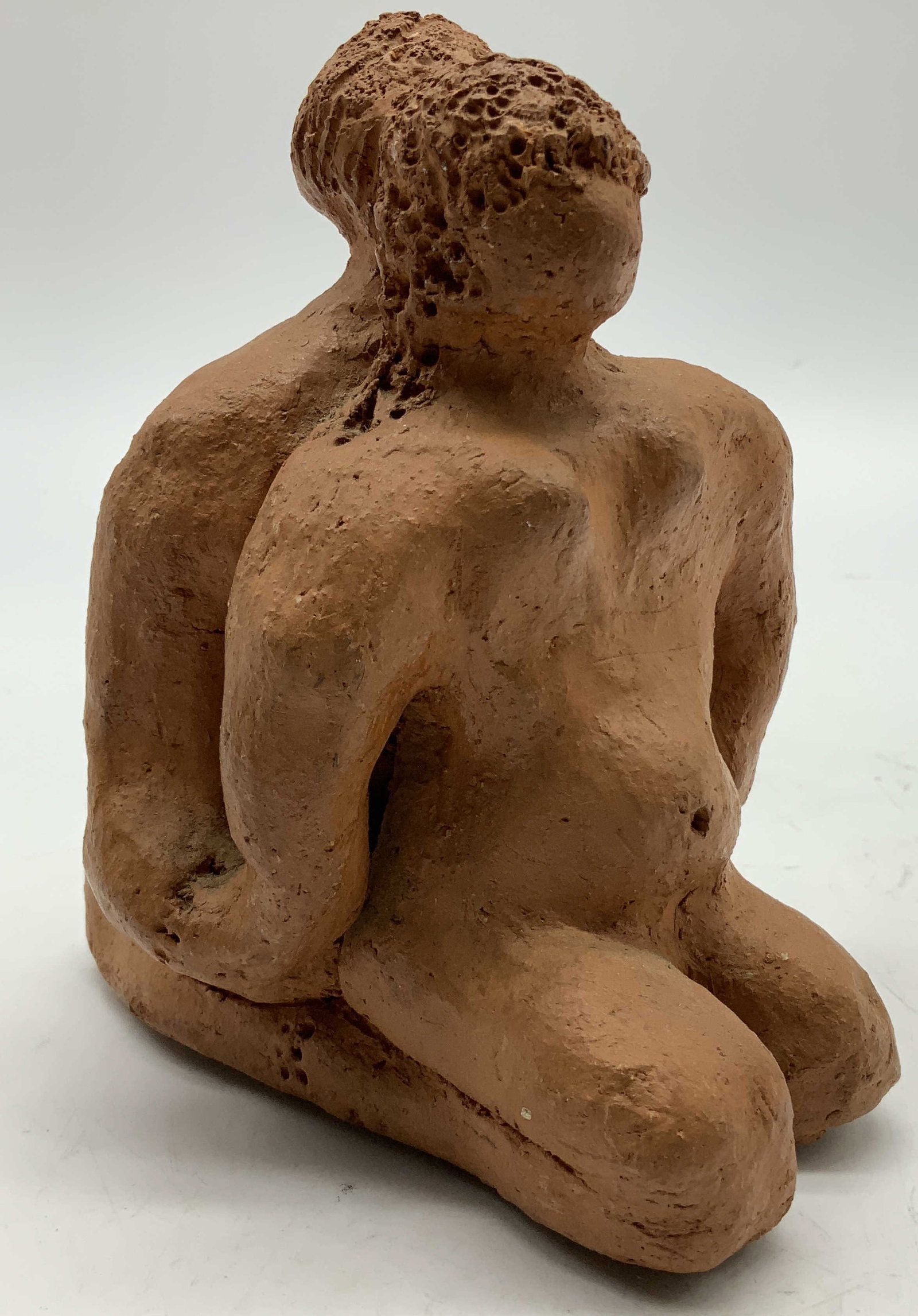 Sgnd Handmade Pottery Intertwined Figurine: Pottery fig depicting two intertwined individuals. Kneeling position & holding hands. Handmade. Surface wear consistent to age, use & exposure. Measurements: length 4.5in x width 3.7in x height 5.4in.