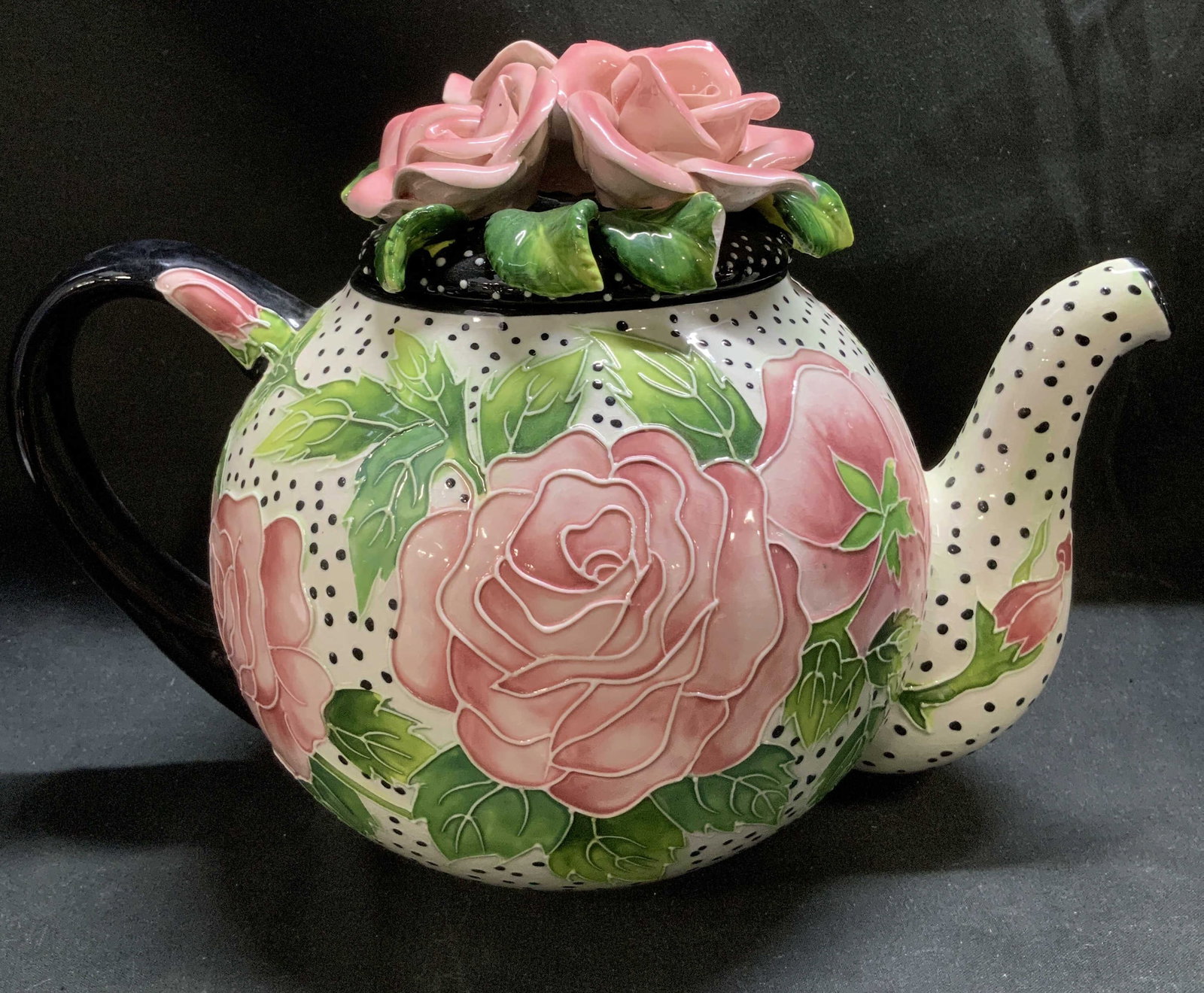 Vtg Hand Painted Roses Ceramic Teapot: Vintage ceramic teapot features a white body with black polka dots. Lid has raised pink roses. Glossy finish. Surface wear consistent to age, use & exposure. Measurements to handle: length 9.5in x wid