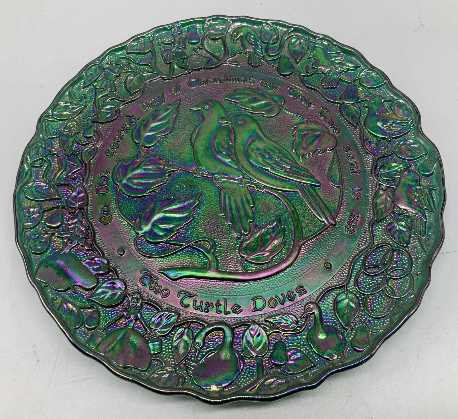 Vtg Imperial Carnival Glass Limit Ed Plate: Vintage imperial green carnival glass, Two Turtles Doves plate from the 12 days of Christmas series. Raised design featuring 2 birds in center. Leaf accents. Scalloped edge. Signed & marked on undersi