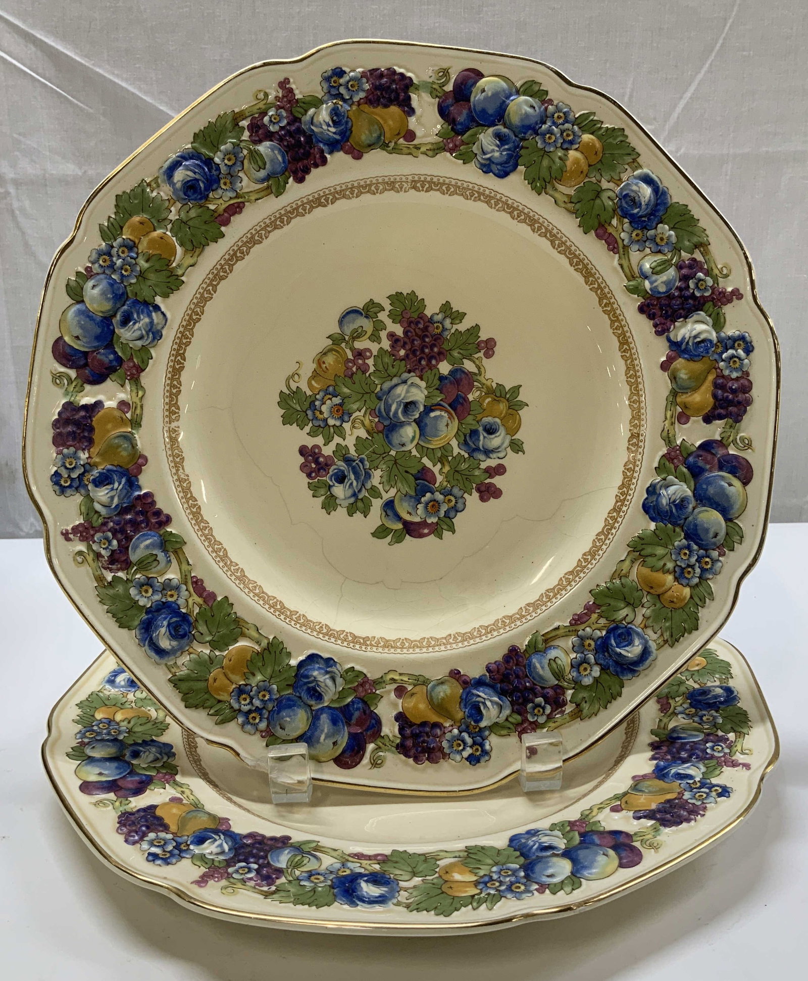 Set 2 Crown Ducal Horentine Plates ENGLAND: Set 2 of Crown Ducal Horentine dinner plates featuring a raised fruit & flower design. Cream background. Ceramic material. Gilt accents. Signed & marked on underside. Reads, CROWN DUCAL HORENTINE. MAD