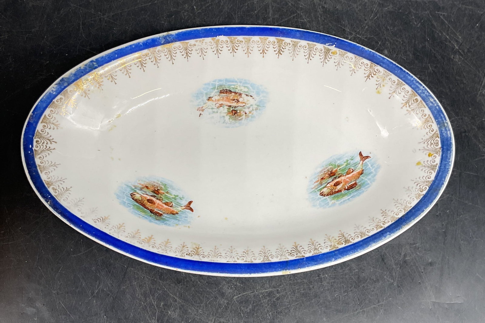 Vintage Pope Gosser Porcelain Fish Bowl: Vintage, possibly antique, signed Pope Gosser porcelain oval bowl with hand painted and gilt fish motif. Measures approx. 8.5 x 5.25 x 1.25 inches. Wear including scratching and loss to paint. Pope Go