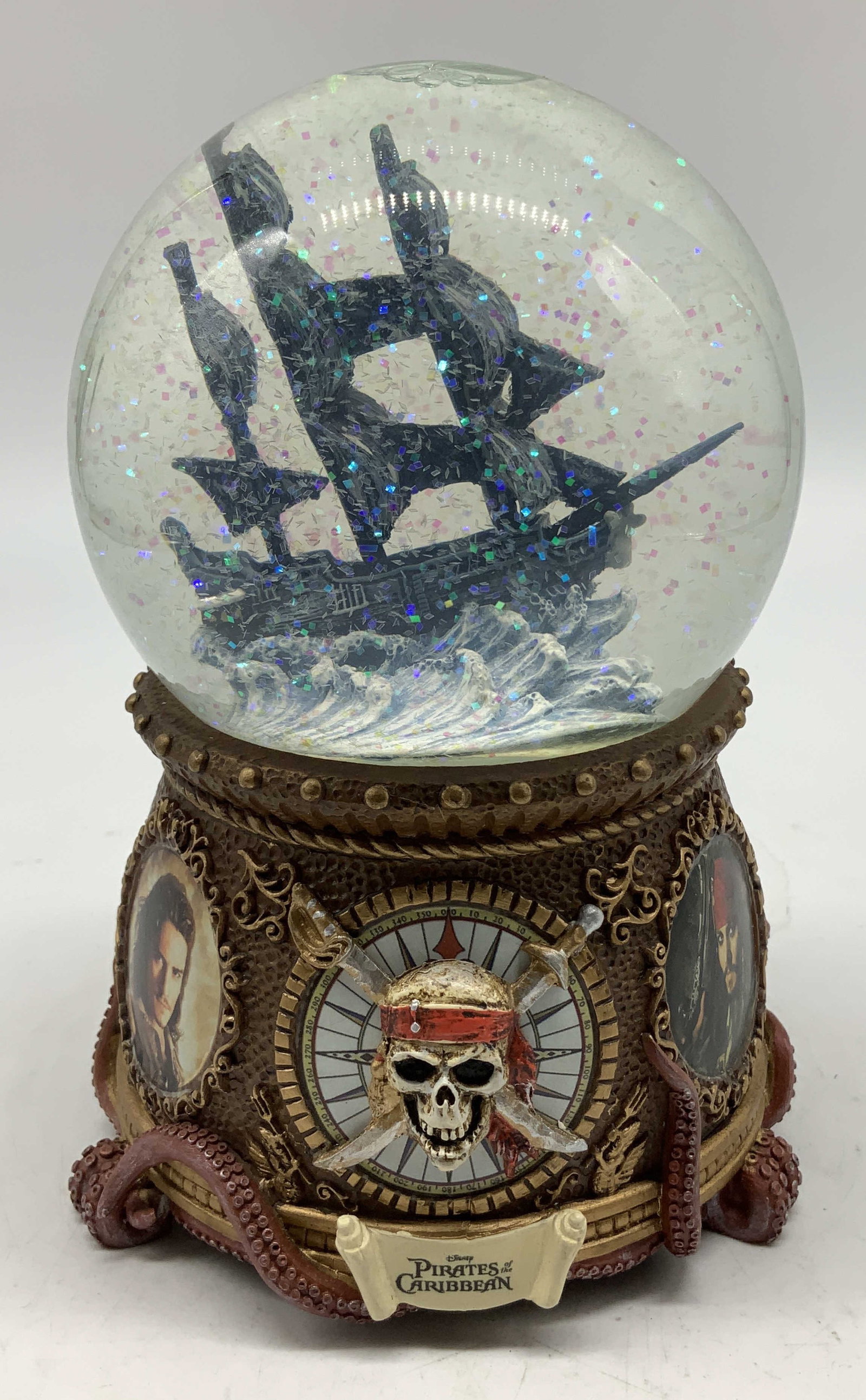 Disney Pirates of the Caribbean Musical Globe: Disney Pirates of the Caribbean musical glitter globe featuring the Black Pearl ship. Resin material. Signed & marked on underside. Reads, YO HO (A PIRATES LIFE FOR ME). MUSIC BY GEORGE BRUNS, WORDS B