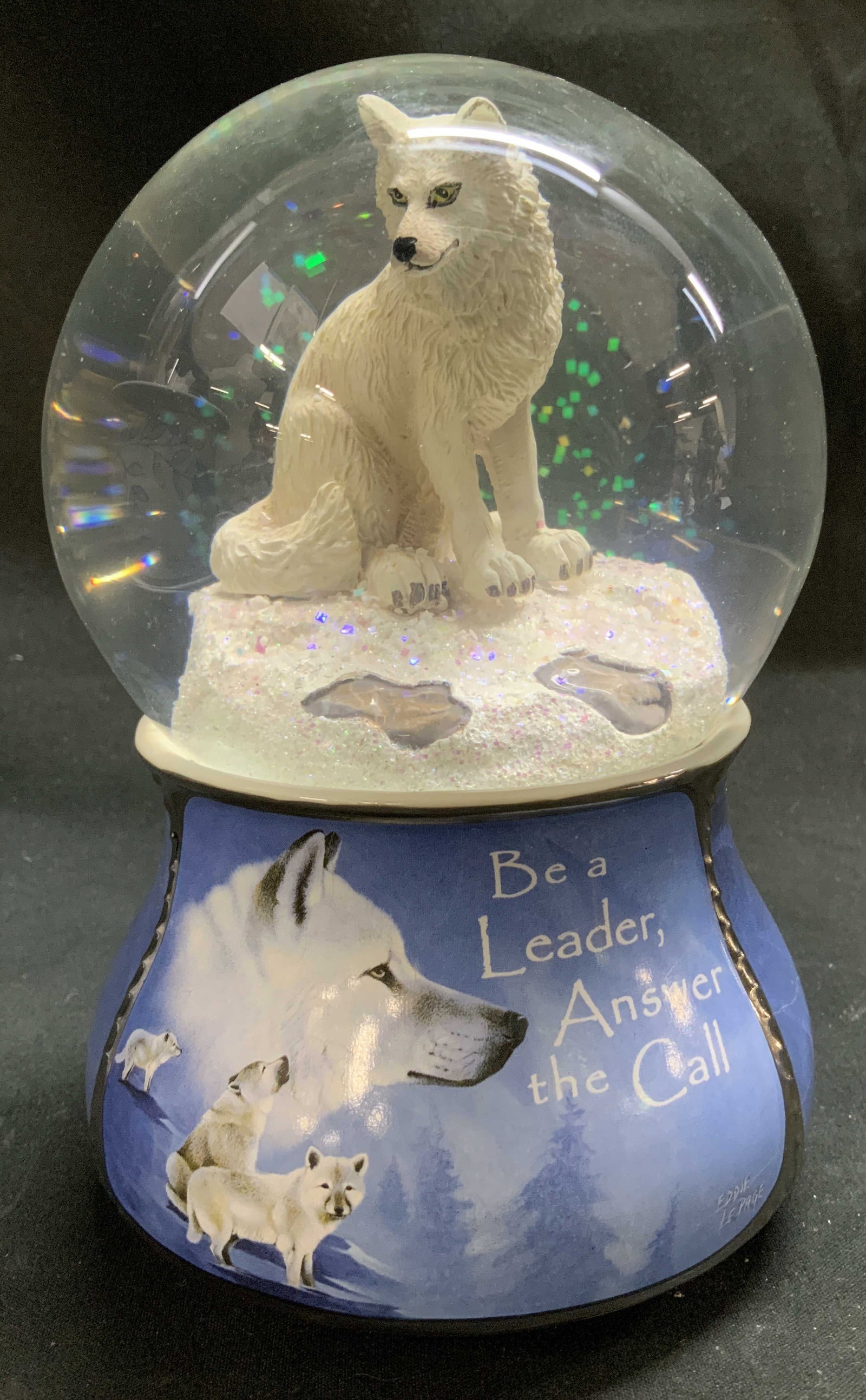 2020 Bradford Spirits Within Glitter Musical Globe: 2020 Bradford Exchange Spirits Within musical glitter globe featuring artwork by Eddie LePage. Interior features a white wolf & text on exterior reads, Be a Leader, Answer the Call. Plays, Serenade No