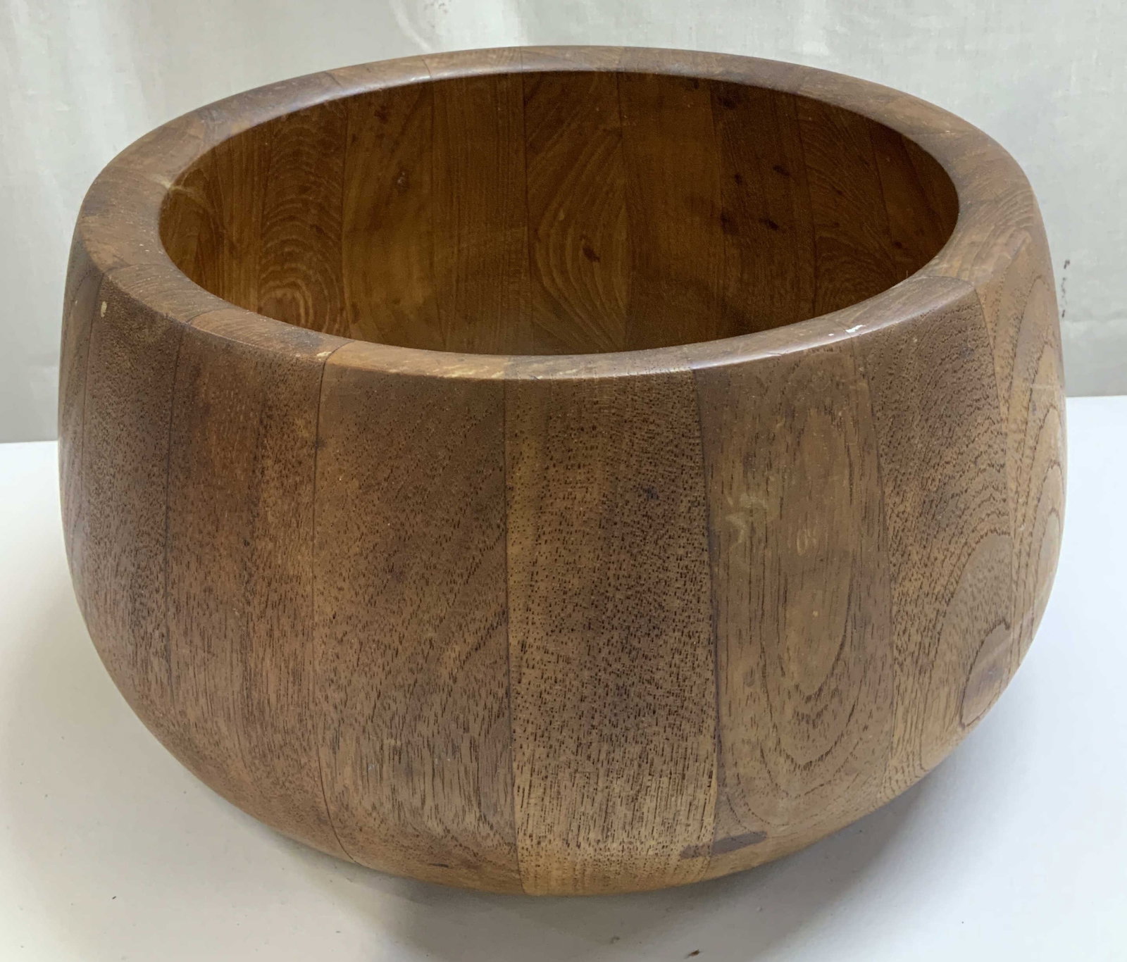 Dansk International Staved Teak Salad Bowl: Dansk International salad bowl is crafted of staved tweak wood. Brown toned. Signed & marked on underside. Reads, DANSK INTERNATIONAL DESIGNS LTD. Surface wear consistent to age, use & exposure. Measu
