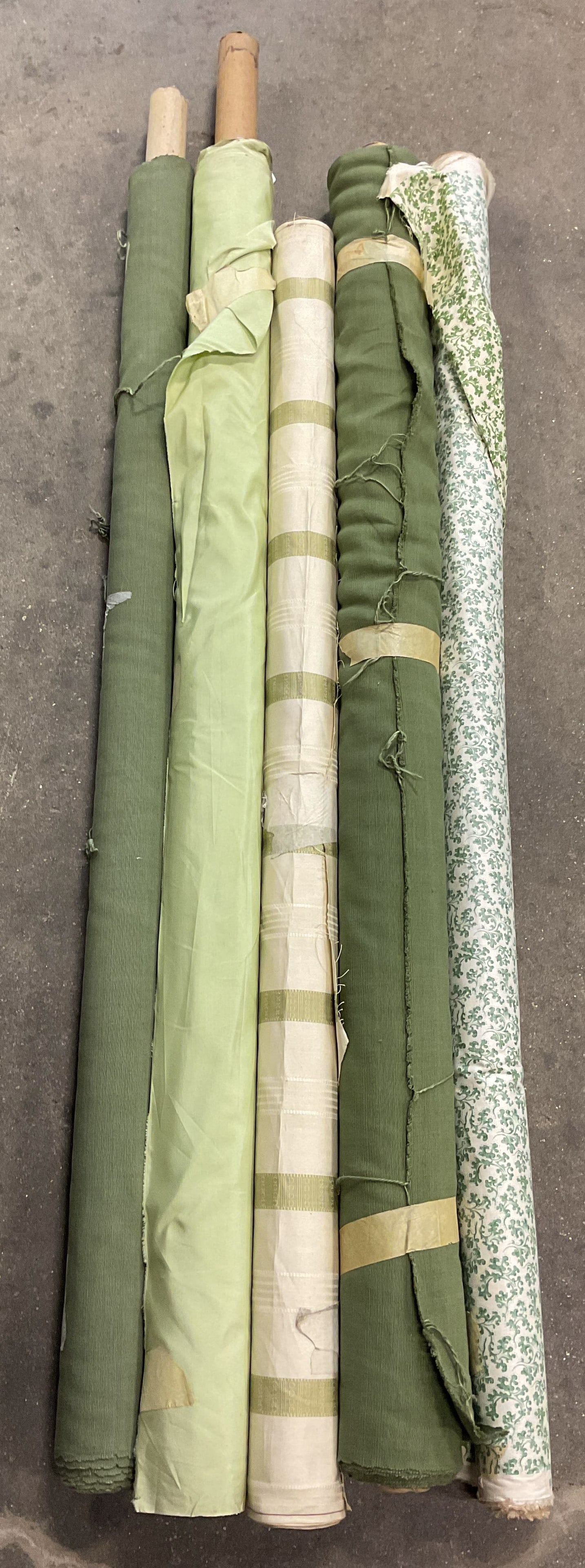 Group Lot 5 Green Cotton Fabric Bolts: Lot of 5 designer fabric bolts. Cotton. Floral, striped, and solid prints. White and green. Not Measured, Unrolled, or Inspected. Sold As Is. Part of Large Collection of NYC Interior Designers Estate.