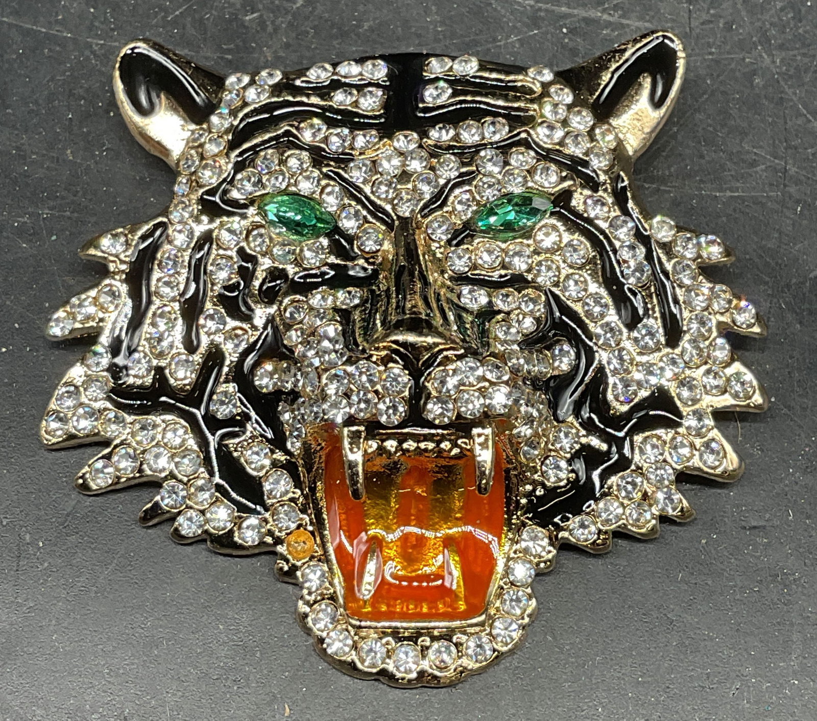 Gold Tn Enamel Crystal Tiger Head Brooch: Gold tone enameled and crystal decorated tiger head brooch. Measures approx. 2.25 x 2.25 inches. Some scratching. One crystal needs replacement. Jewelry, estate jewelry, costume jewelry, cocktail jewe