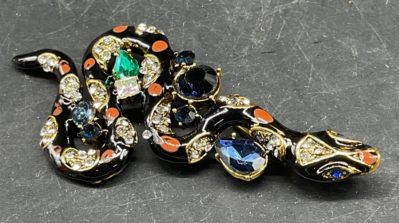 Vintage Gold Tone Enamel Crystal Snake Brooch: Vintage gold tone Enamel and crystal decorated snake motif brooch. Measures approx. 3.25 x 1.5 inches. Some scratching. Jewelry, estate jewelry, costume jewelry, cocktail jewelry, fashion jewelry, acc