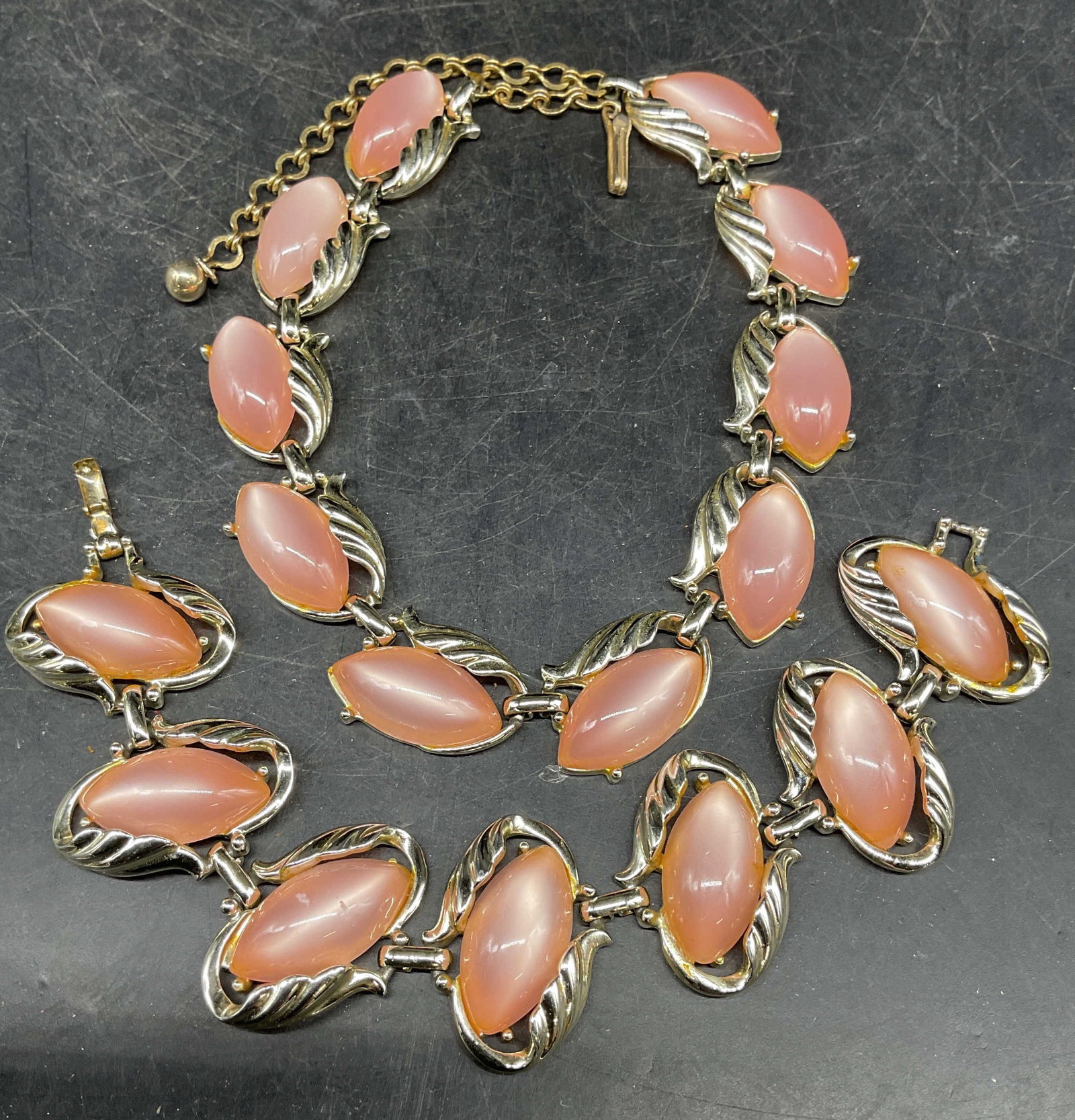 Pair Silver Tone Pink Necklace & Bracelet: Pair of vintage matching silver and pink lucite cabochon panel necklace and bracelet. Bracelet measures approx. 7 inches long. Necklace drop length measures approx. 7 inches. Some scratching. Jewelry,