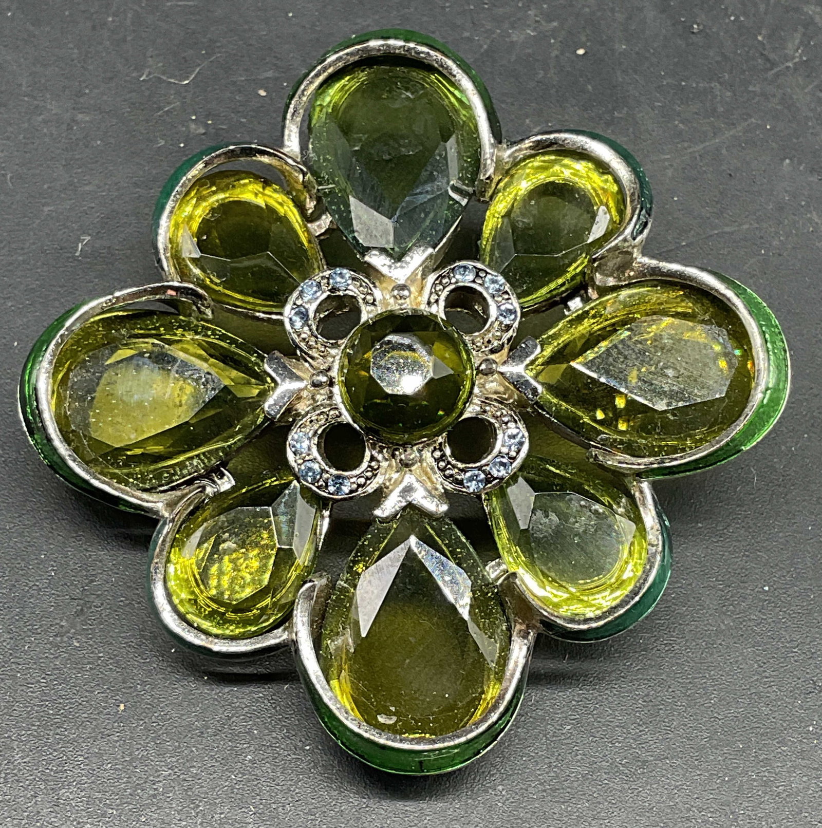 Vintage Monet Silver Tone Green Crystal Brooch: Vintage signed Monet silver tone enamel and green crystal brooch. Measures approx. 2 x 2 inches. Some scratching. Jewelry, estate jewelry, costume jewelry, cocktail jewelry, fashion jewelry, accessori