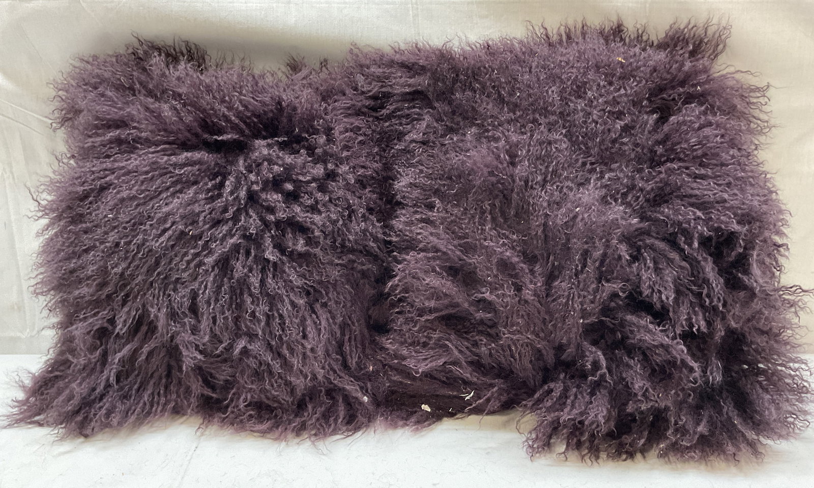 Pair Woolmark Interiors Sheepskin Throw Pillows: Pair of Woolmark Interiors purple sheepskin throw pillows. Cover front is 100% sheepskin and cover reverse is 100% cotton. Deep purple color. Measures approx 18 x 18 inches. Some shedding. Pillows, th