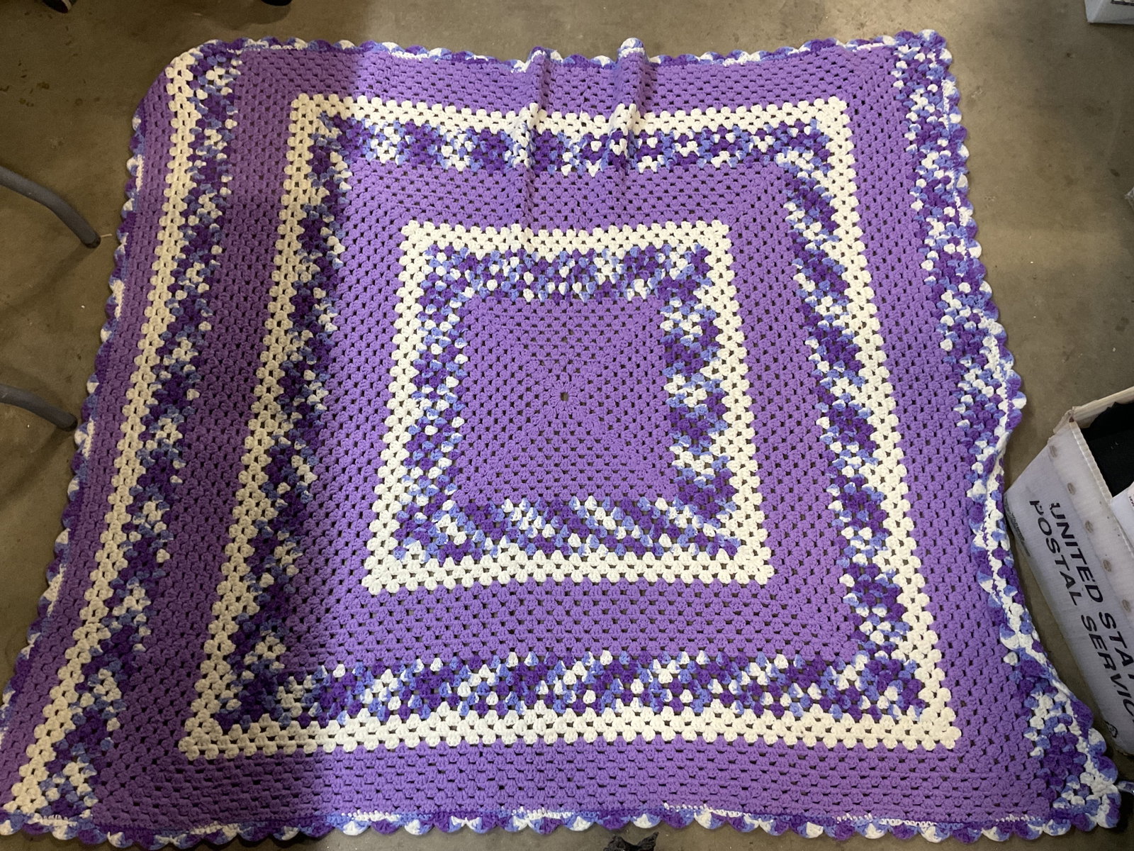 Vtg Hand Made Crocheted Purple Throw Blanket: Vintage hand made crocheted purple throw blanket. Scalloped trim. Geometric pattern in purple, white, and blue. Measures approx 46 x 54 inches. Surface wear consistent with exposure. Throw blanket, bl