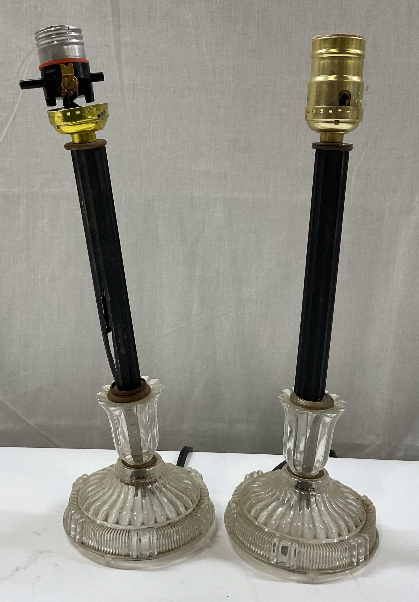 Pair Vtg Art Deco Style Glass Candlestick Lamps: Pair of vintage Art Deco style glass candlestick lamps. Round glass base. Ribbed and scalloped surface. Faceted black stem. Measures ht approx 14 inches base diam approx 5.5 inches. Not tested for fun