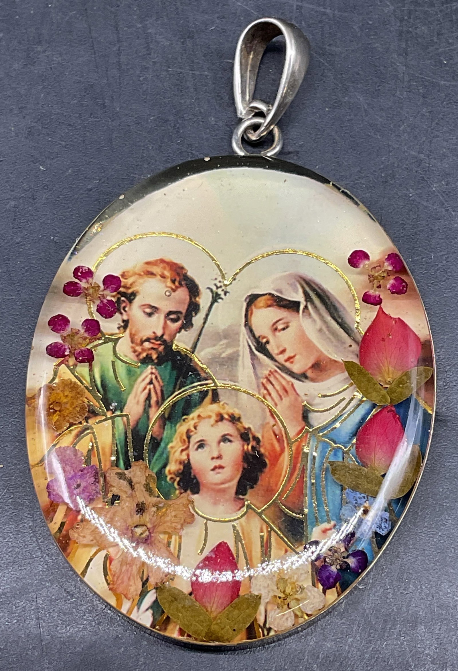 Sterling Silver Holy Family Religious Pendant: Religious motif pendant with dried flowers. Holy family and Virgin Mary. Sterling silver frame, marked 925 ATI Mexico. Measures approx. 1.75 x 1.25 inches. Some scratching. Jewelry, estate jewelry, co